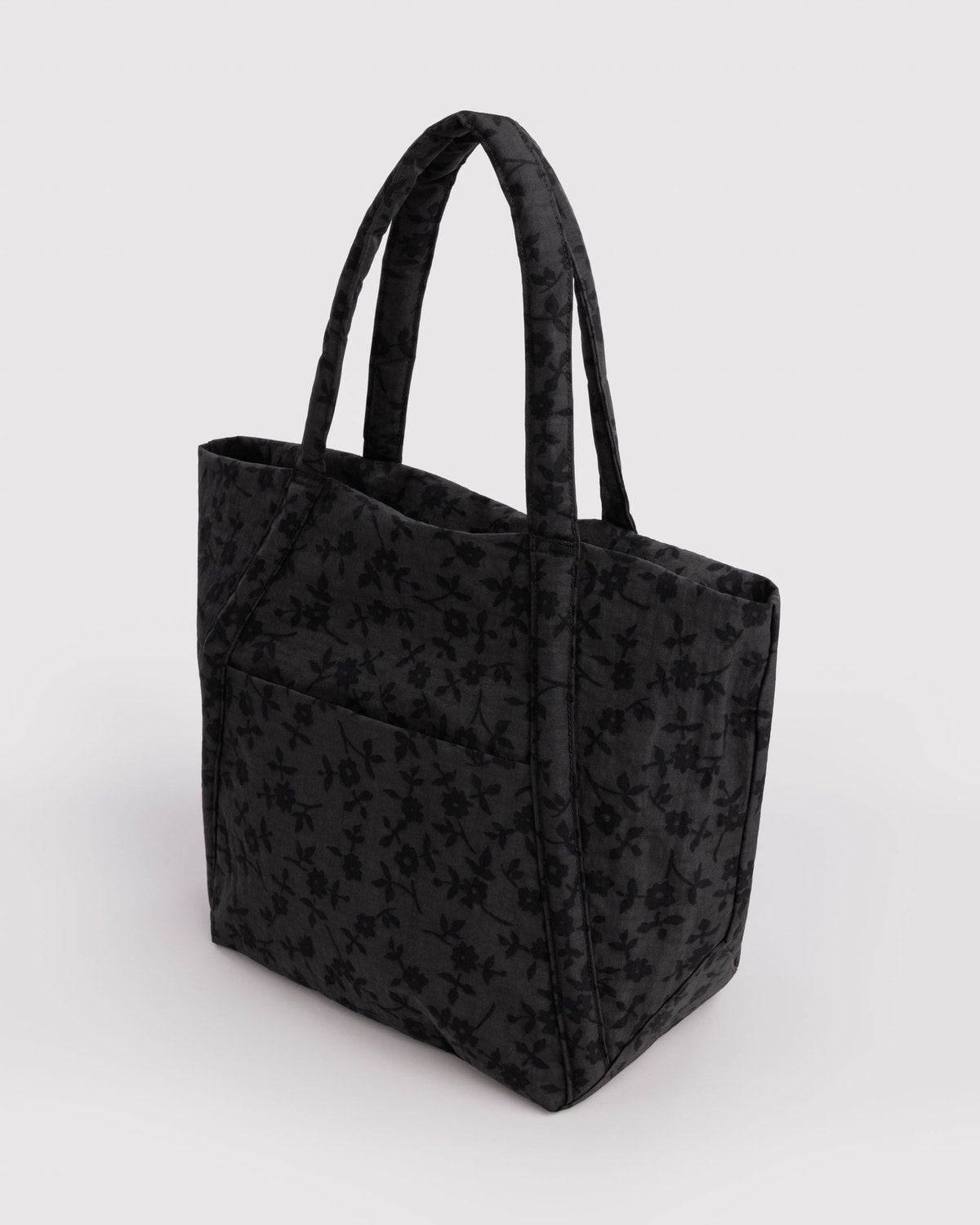 Dark floral tote bag with two top handles and a structured, squared base.