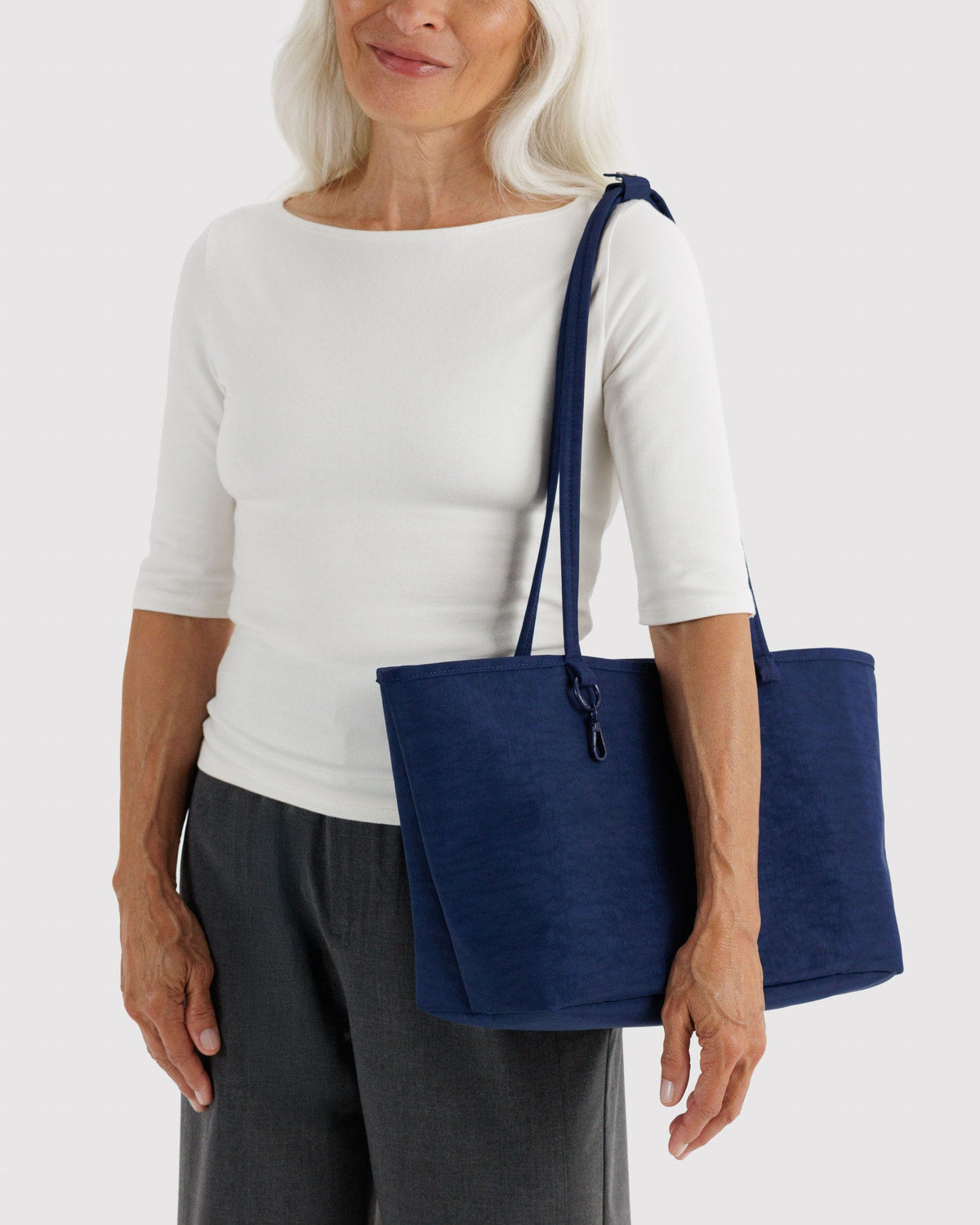Medium nylon reversible tote with top handles and zip closure, navy blue.