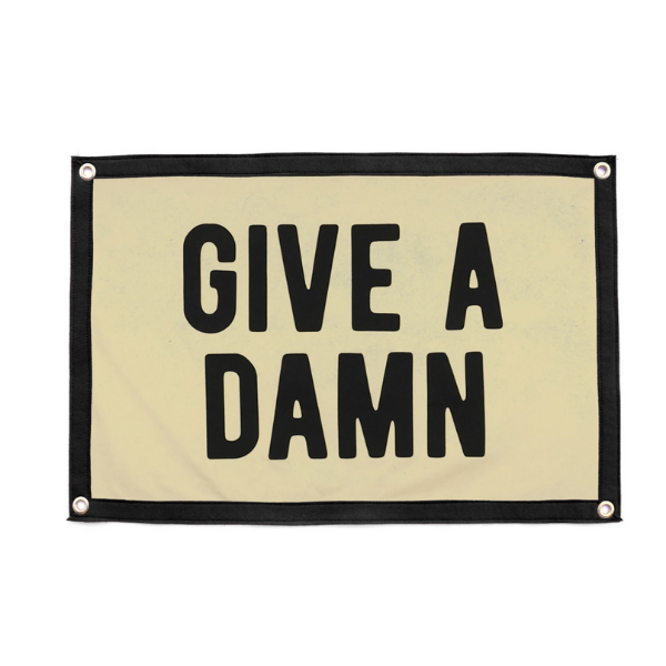 Rectangular camp flag with “GIVE A DAMN” lettering, light fabric and black trim