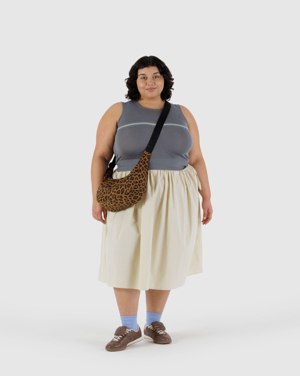 Leopard print nylon crescent bag worn crossbody on plus-size model