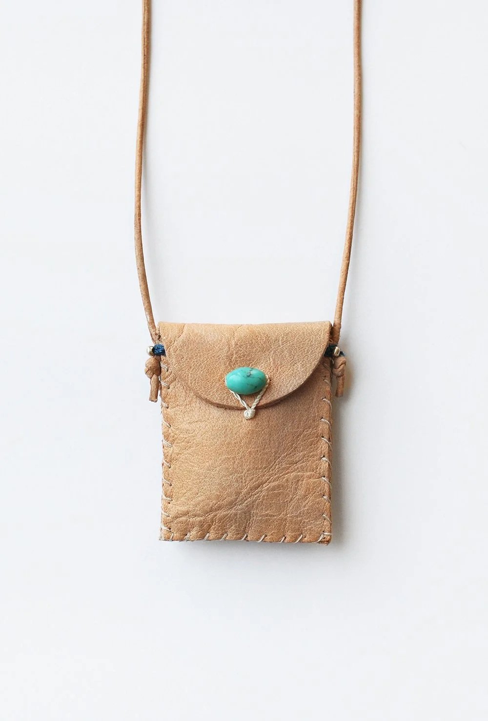 Tan leather amulet pouch with flap, turquoise stone, and side tie cords