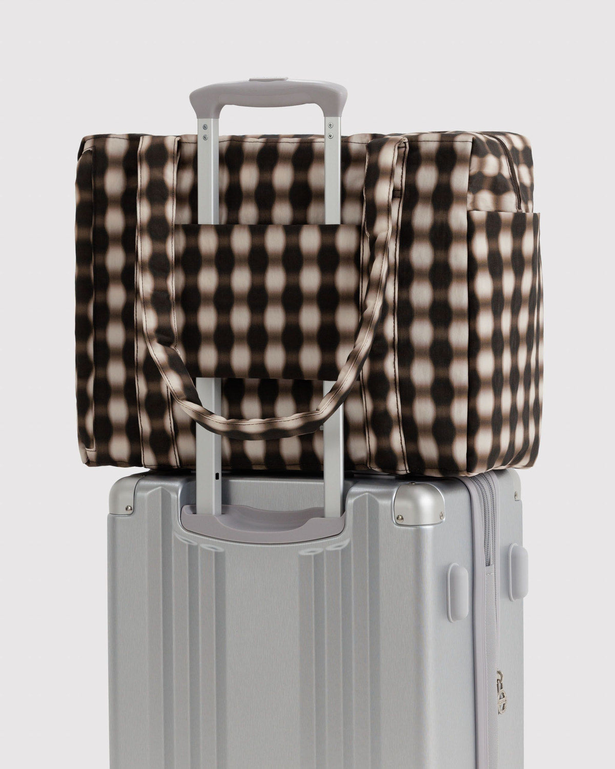Small Cloud carry-on with black-and-cream gingham tote cover and gray wheeled base