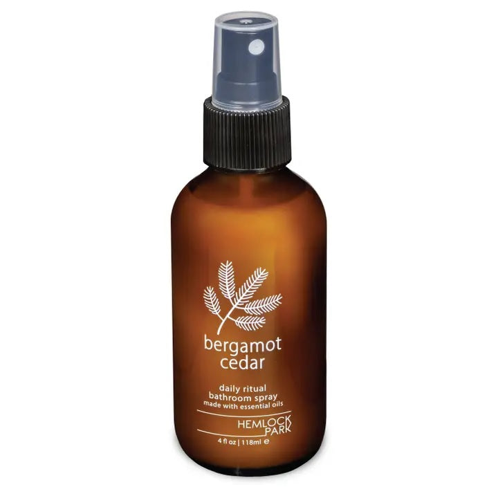 Room spray bottle with bergamot cedar label, amber glass, black ribbed mist nozzle