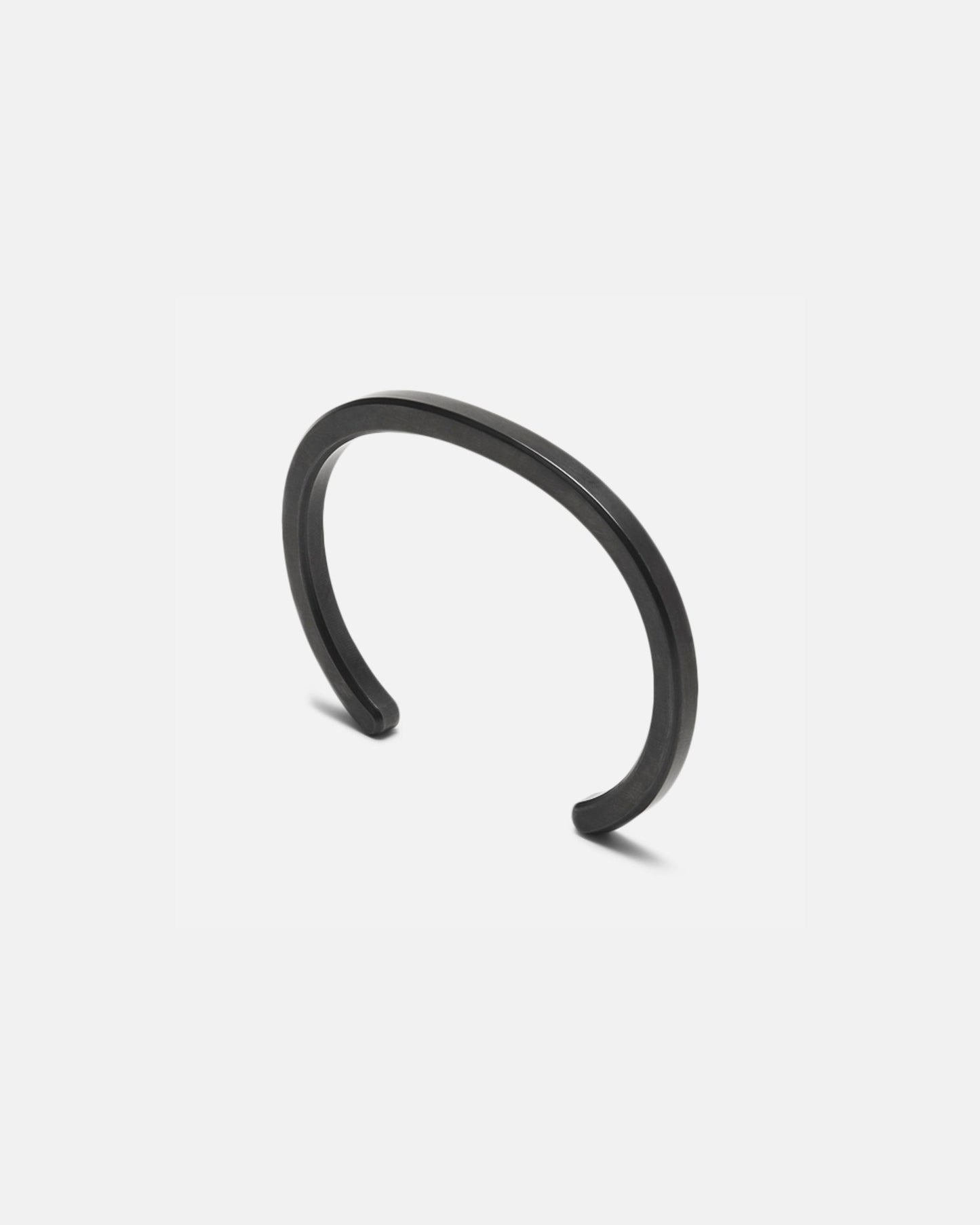 Radial cuff bracelet with dark black curved open bangle and smooth finish
