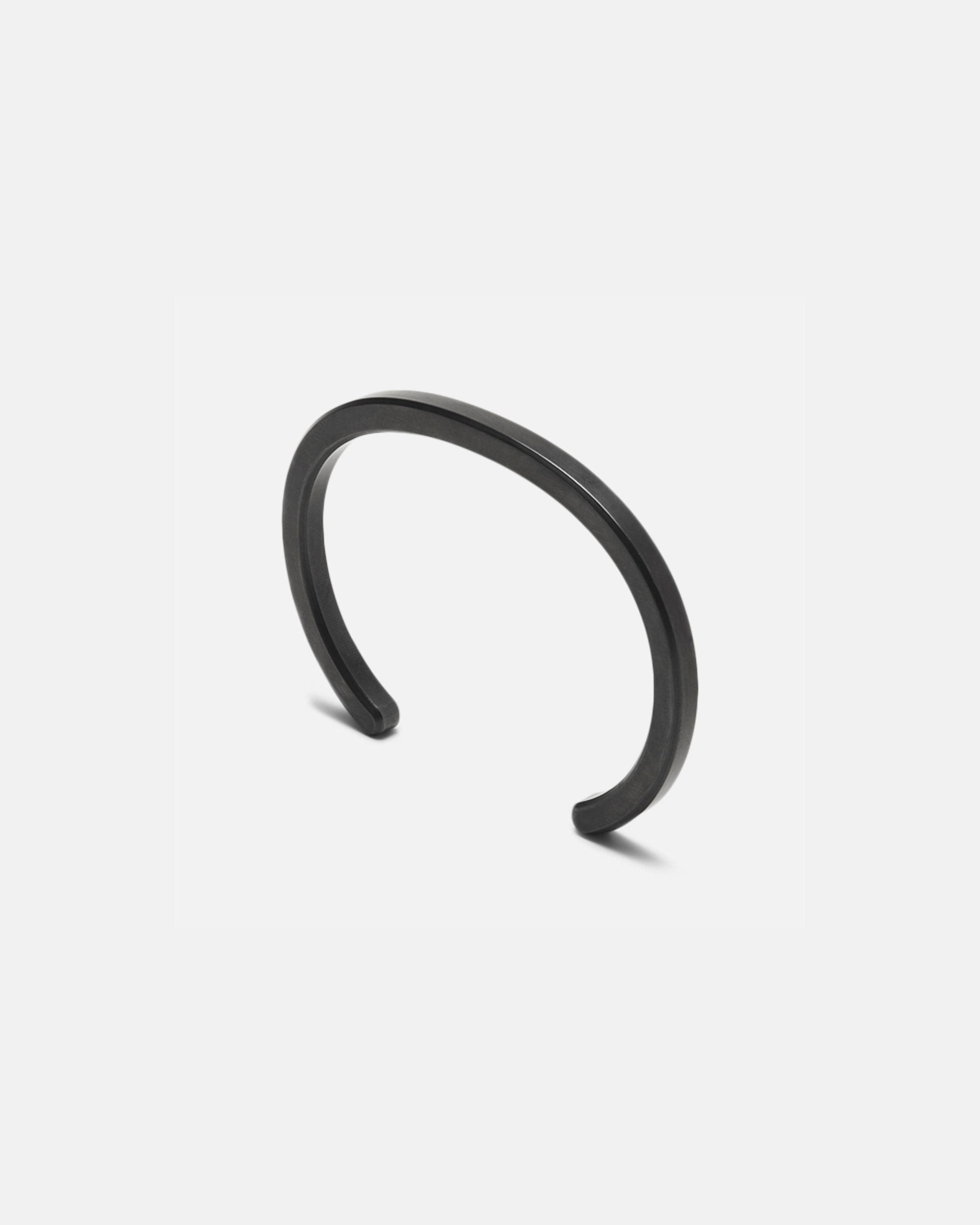 Radial cuff bracelet with dark black curved open bangle and smooth finish