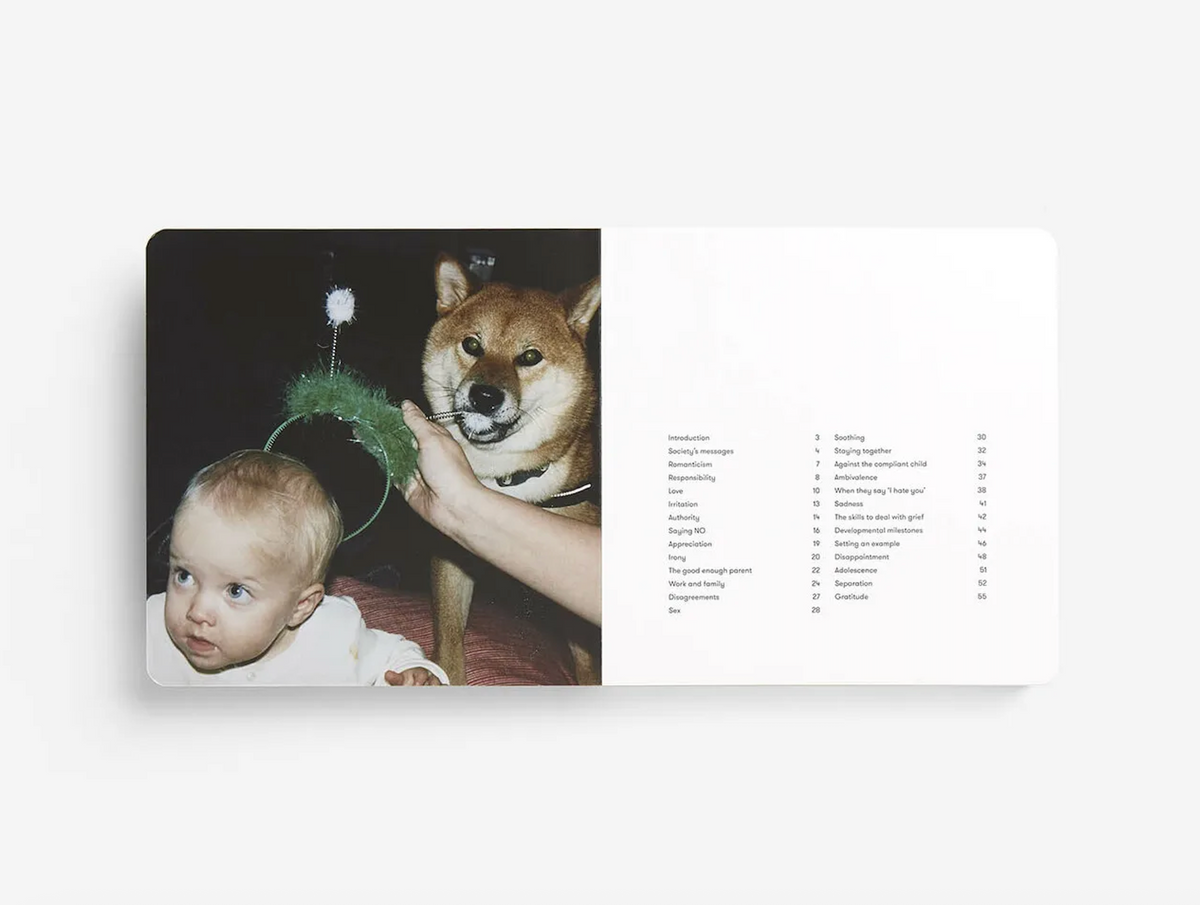 Parenting book open spread with child, dog, and printed page text