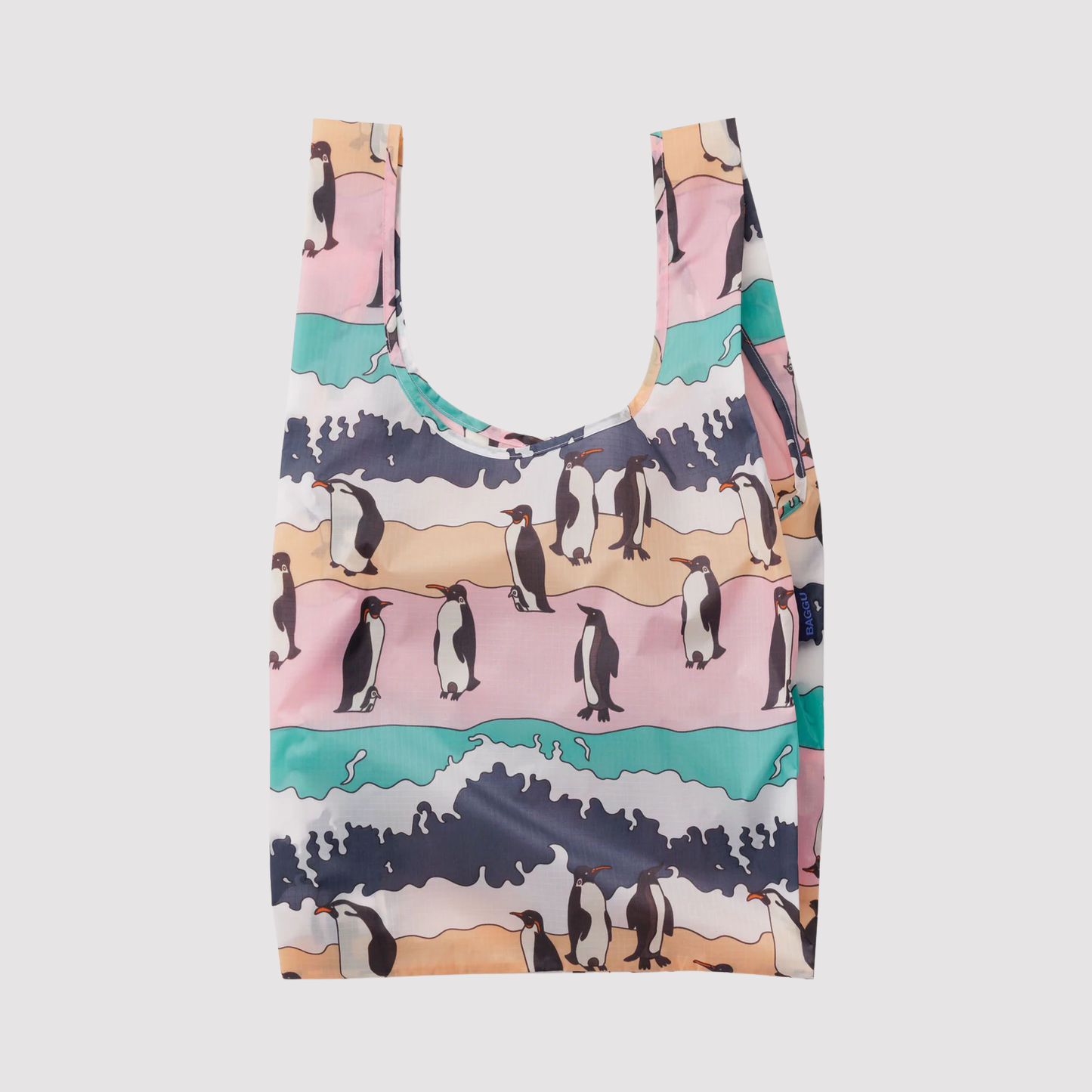 Reusable tote bag with penguin illustration and ocean wave pattern