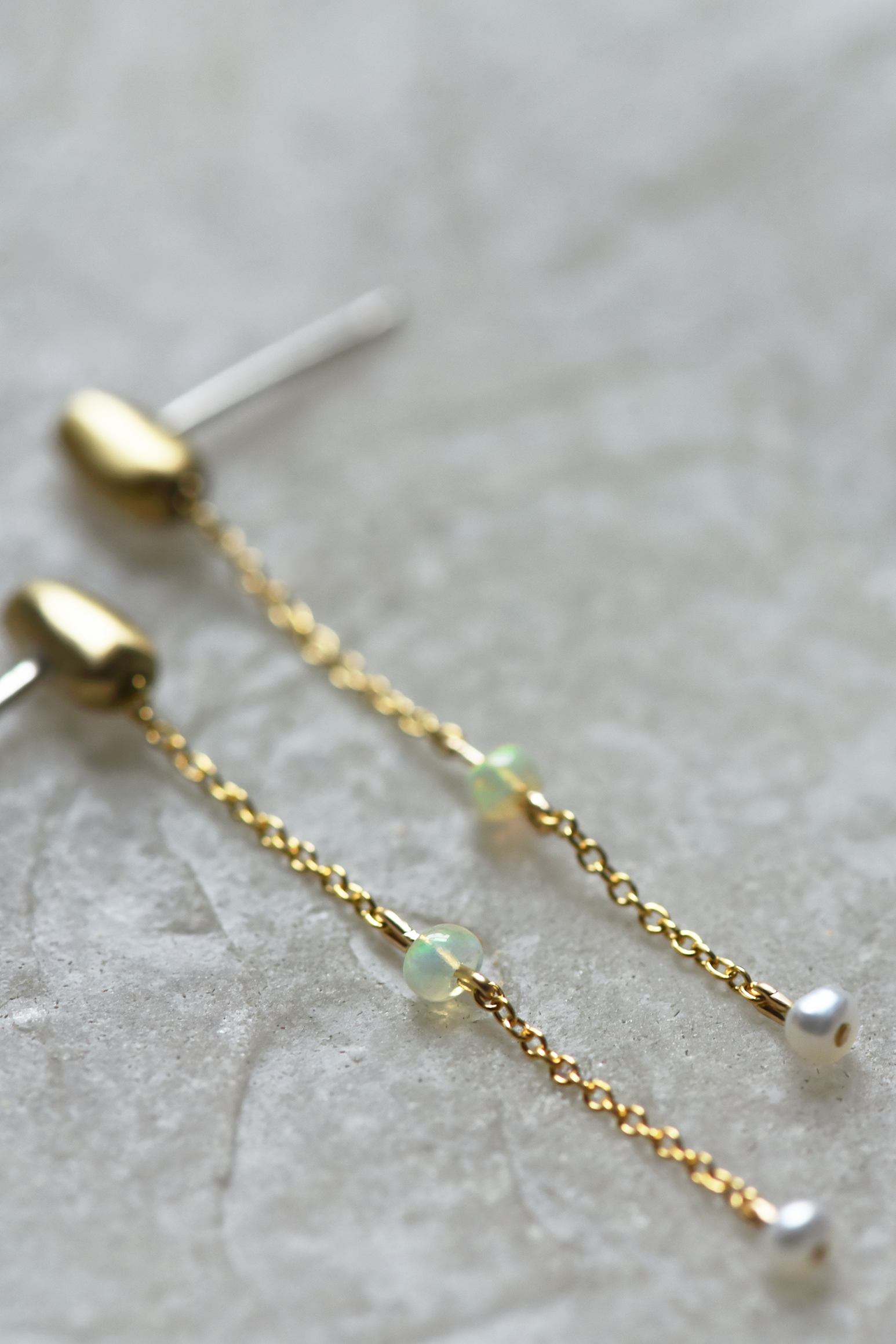 Pair of gold-tone chain drop earrings with green opal bead and white pearl end