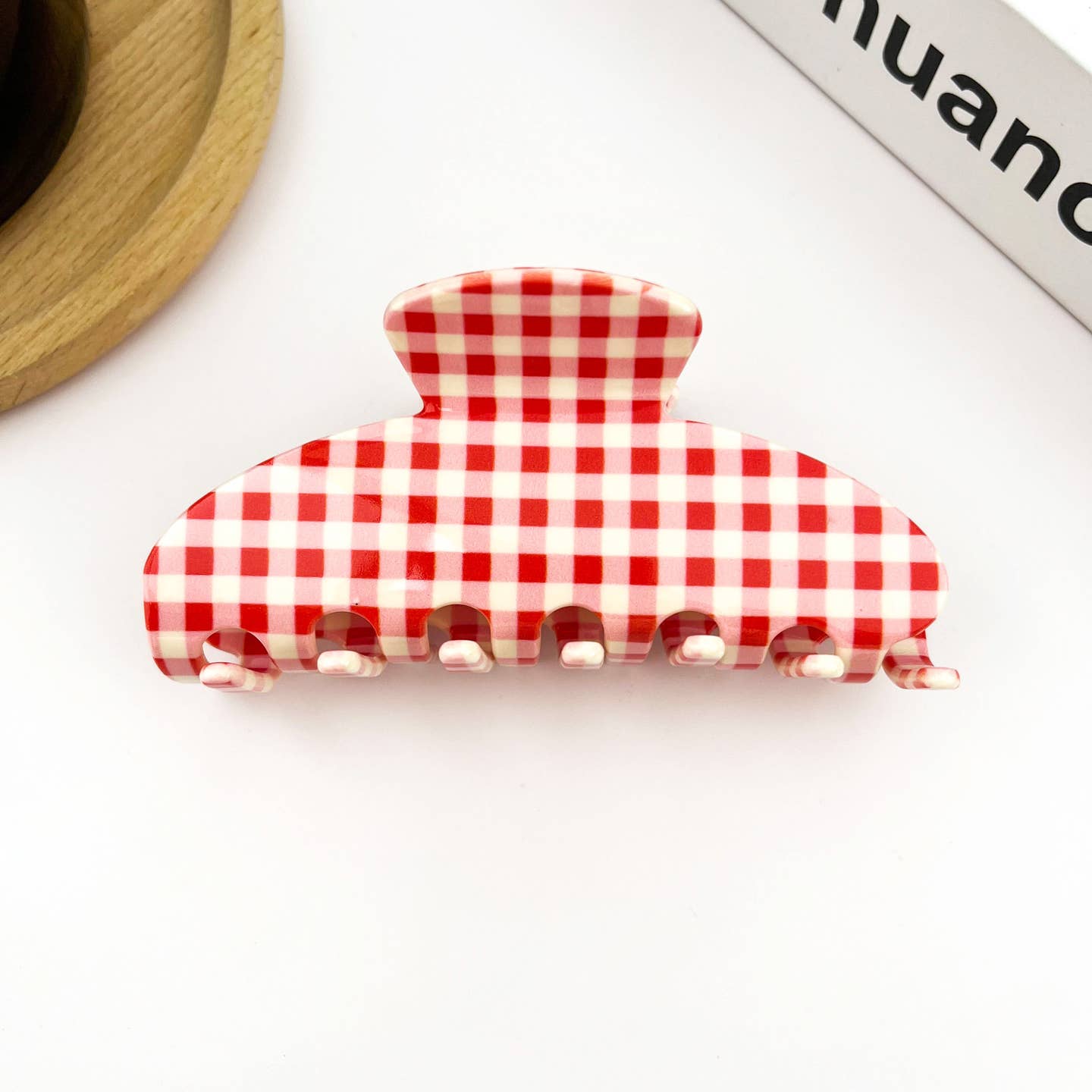 Red and white gingham acetate hair claw clip with ridged metal teeth
