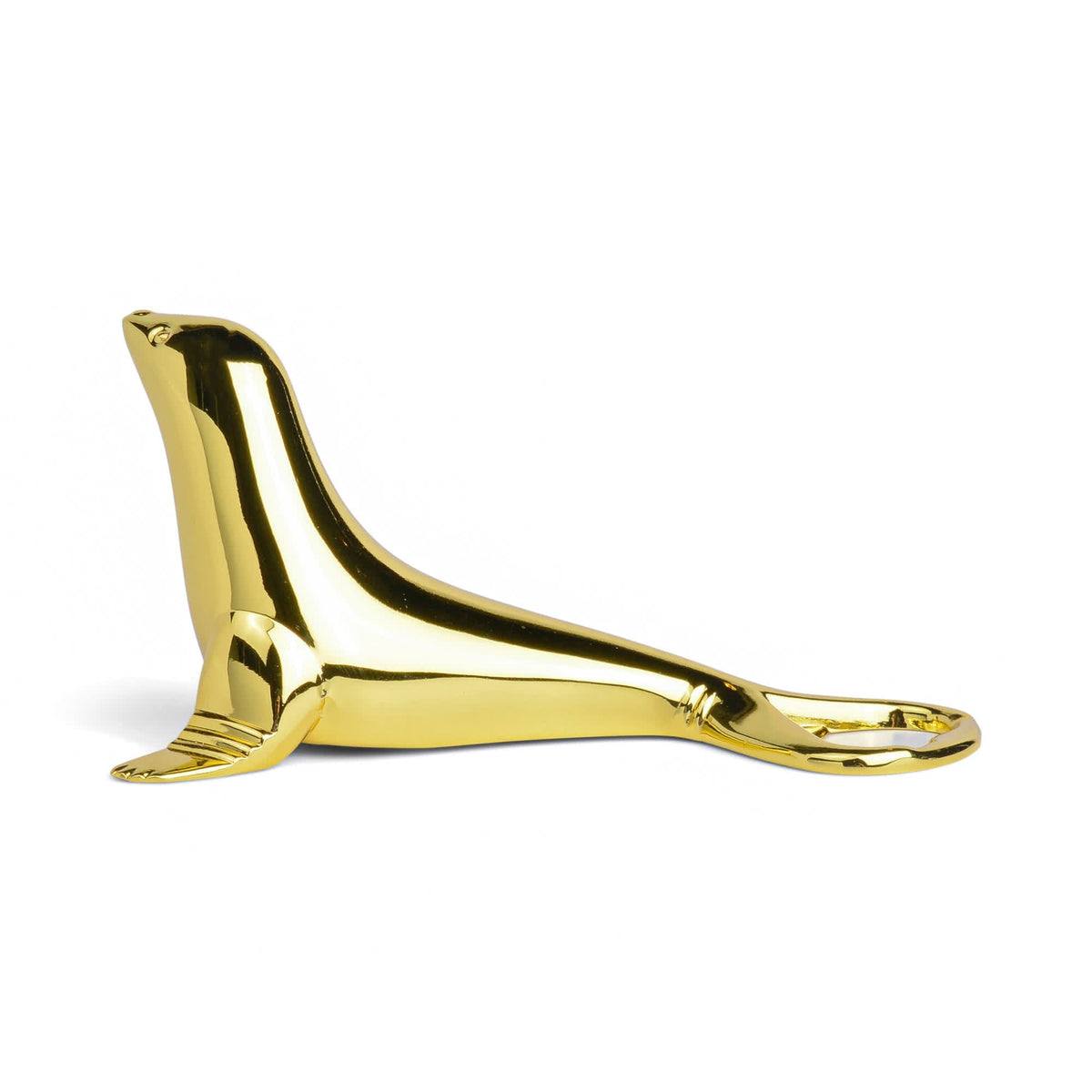 Gold seal-shaped bottle opener lying flat with pull-tab end
