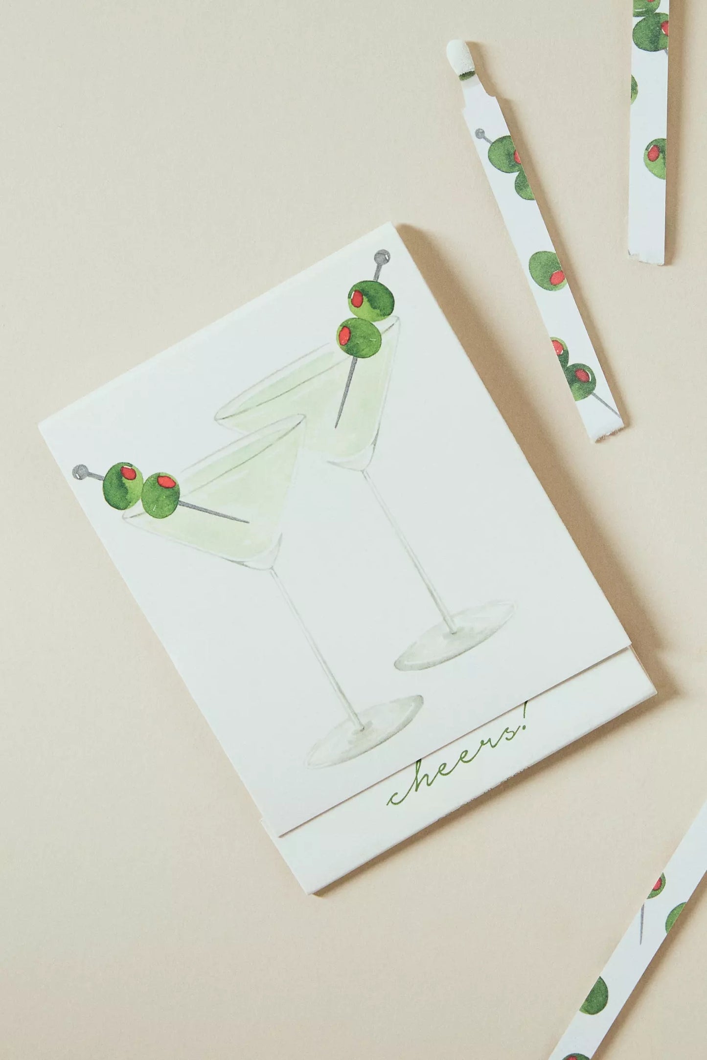 Martini match card with illustrated cocktail glasses and green cherry graphics