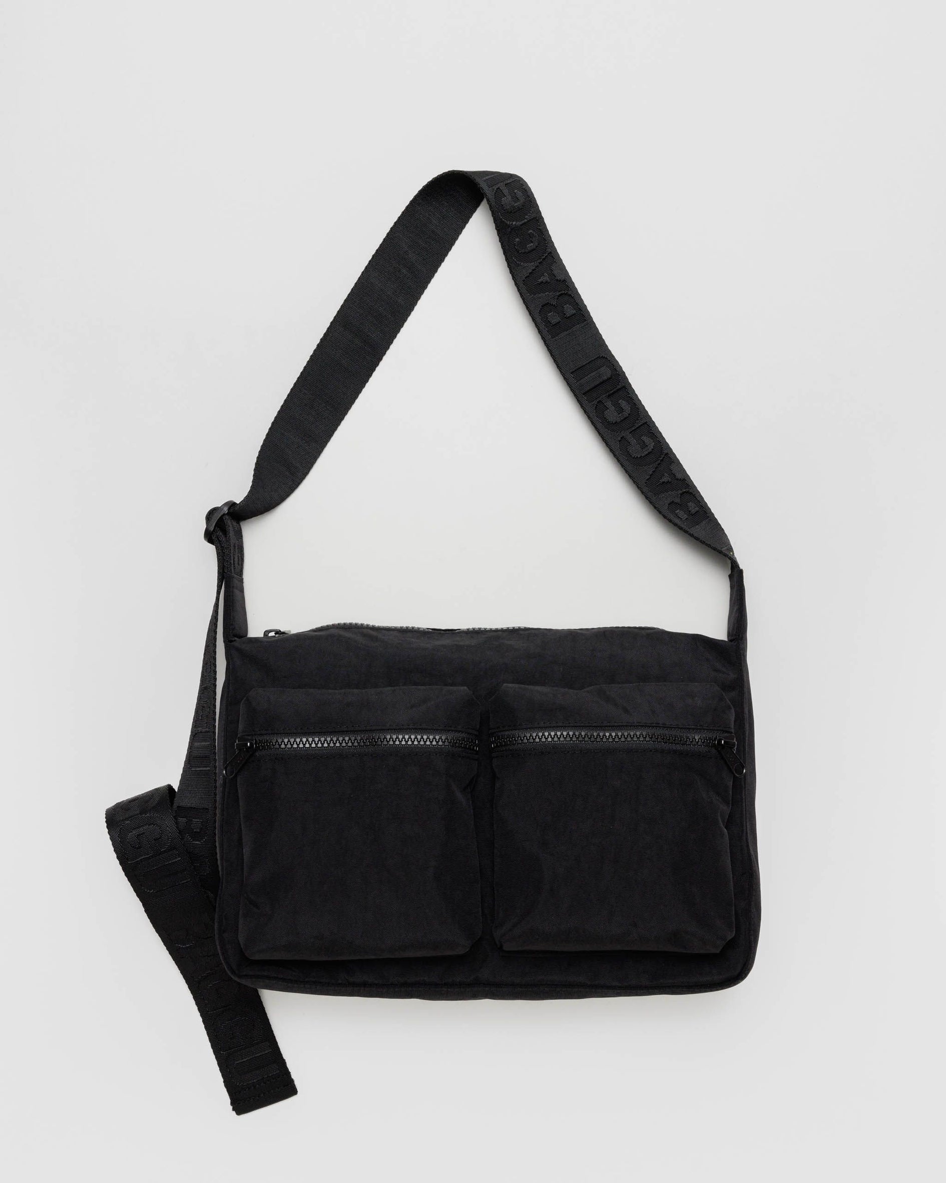 Black medium cargo crossbody bag with two front zip pockets and adjustable strap.