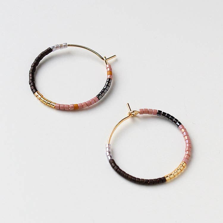 Pair of beaded hoop earrings in black, pink, and gold with gold-tone stud backs