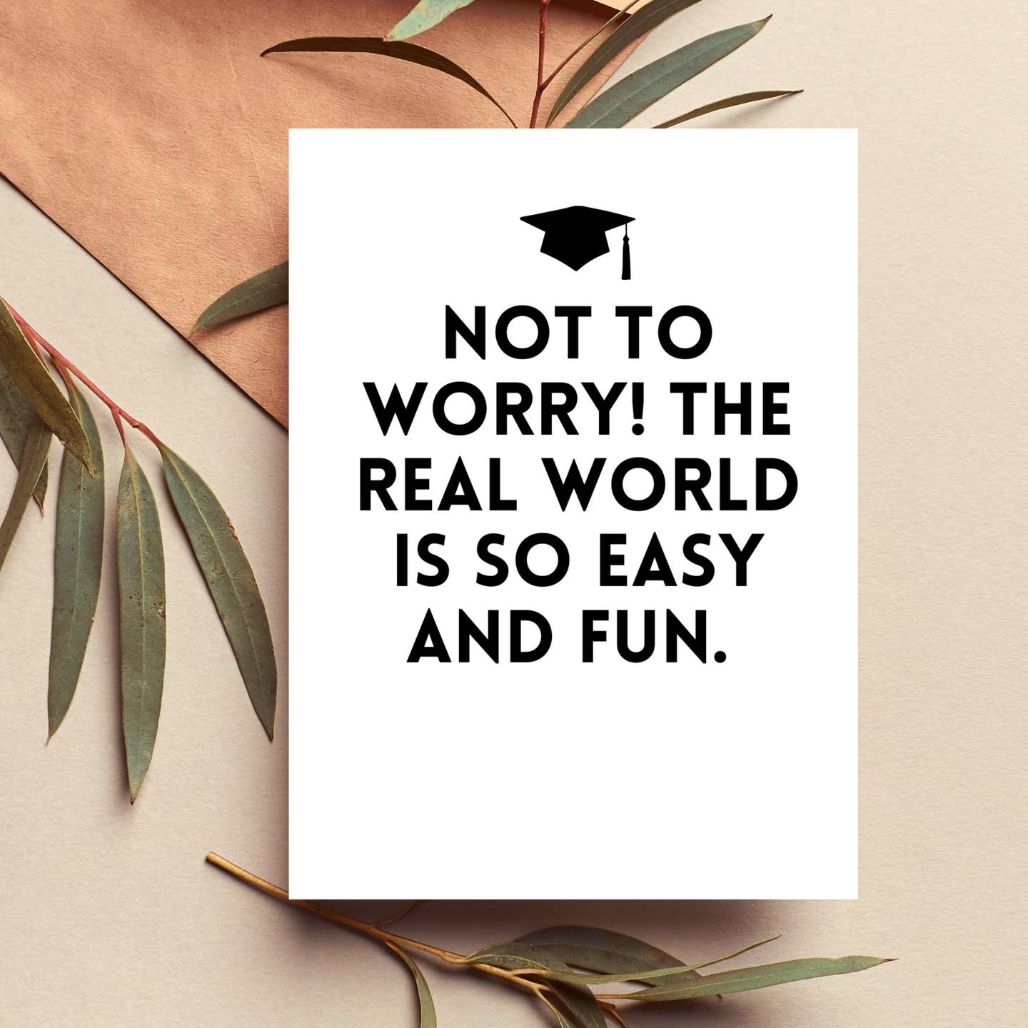 White graduation card, cap icon, text: NOT TO WORRY! THE REAL WORLD IS SO EASY AND FUN.