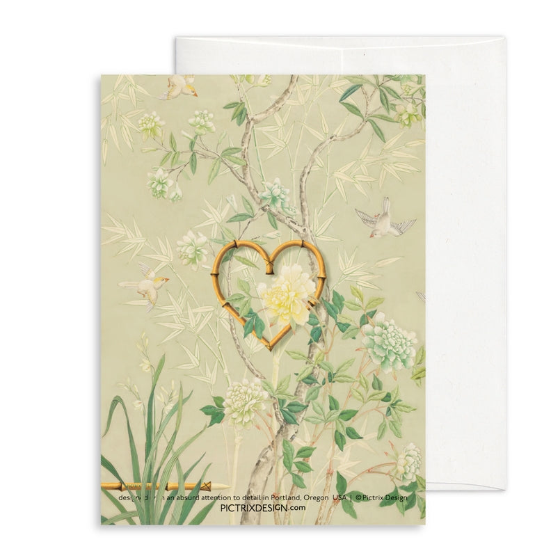Birthday card front with heart motif, white flowers, and small birds on greenery