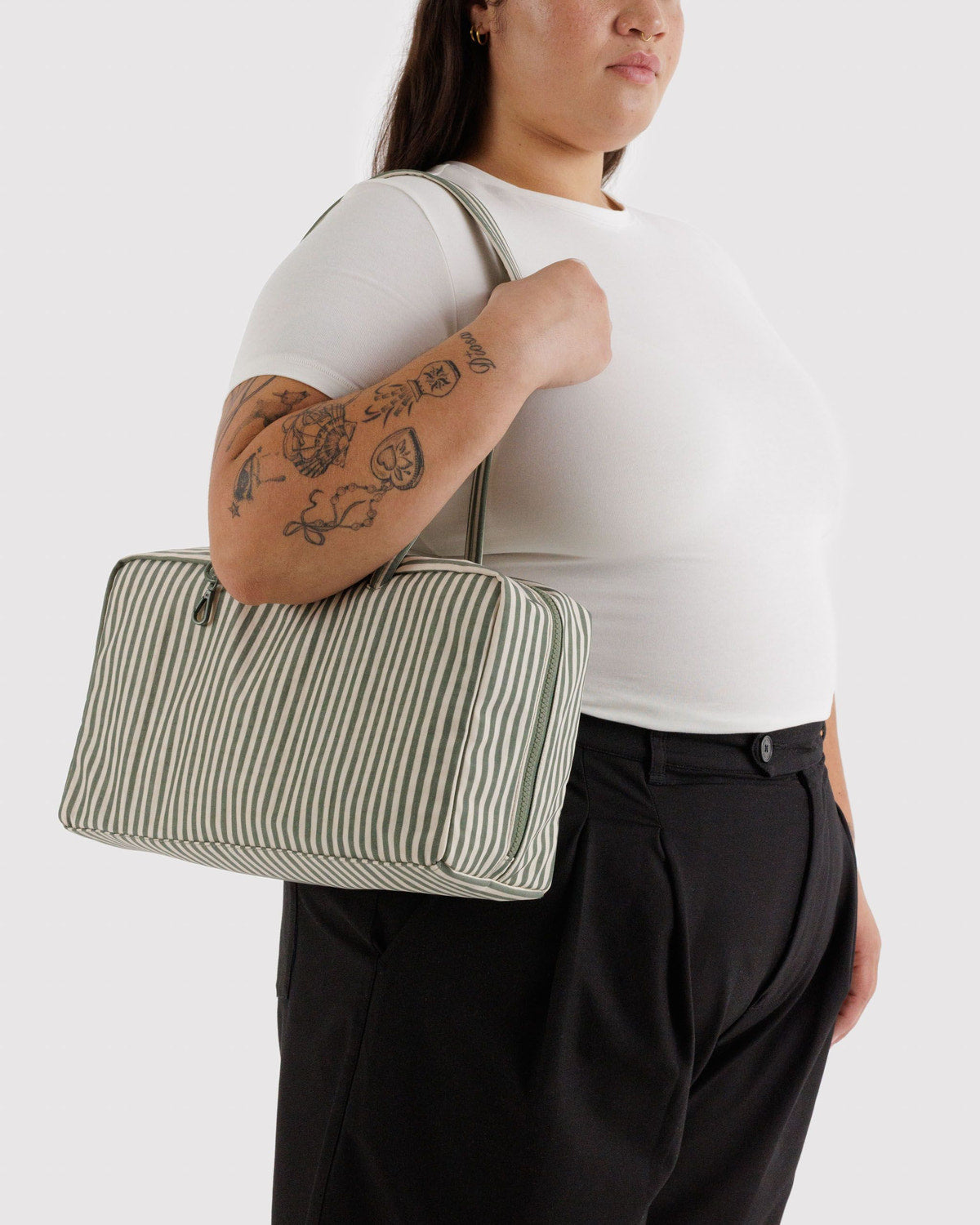Medium nylon bowler bag with sage-and-white vertical stripes, long handles, side carry.