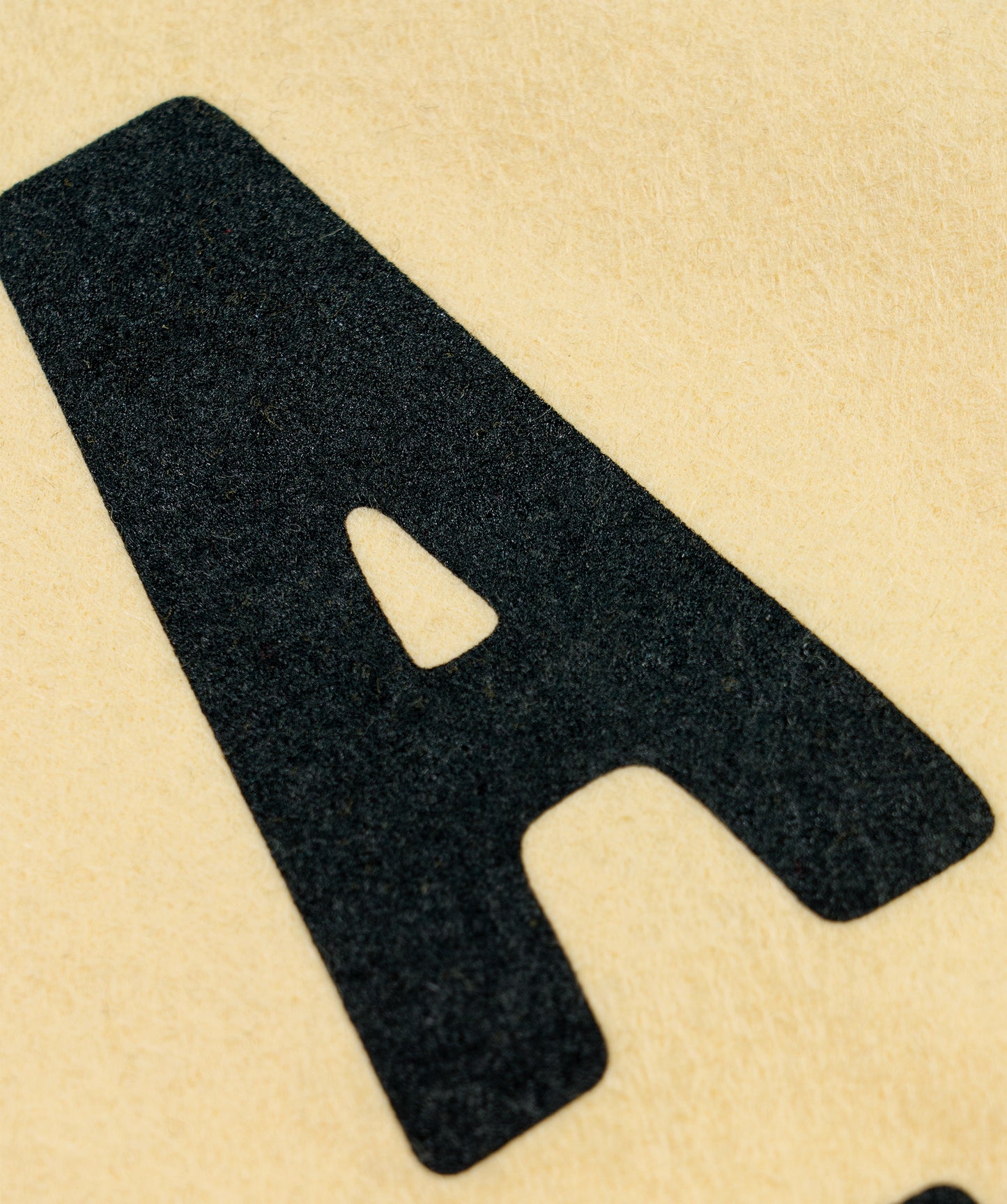 Close-up of camp flag text, showing thick black letters on light tan fabric
