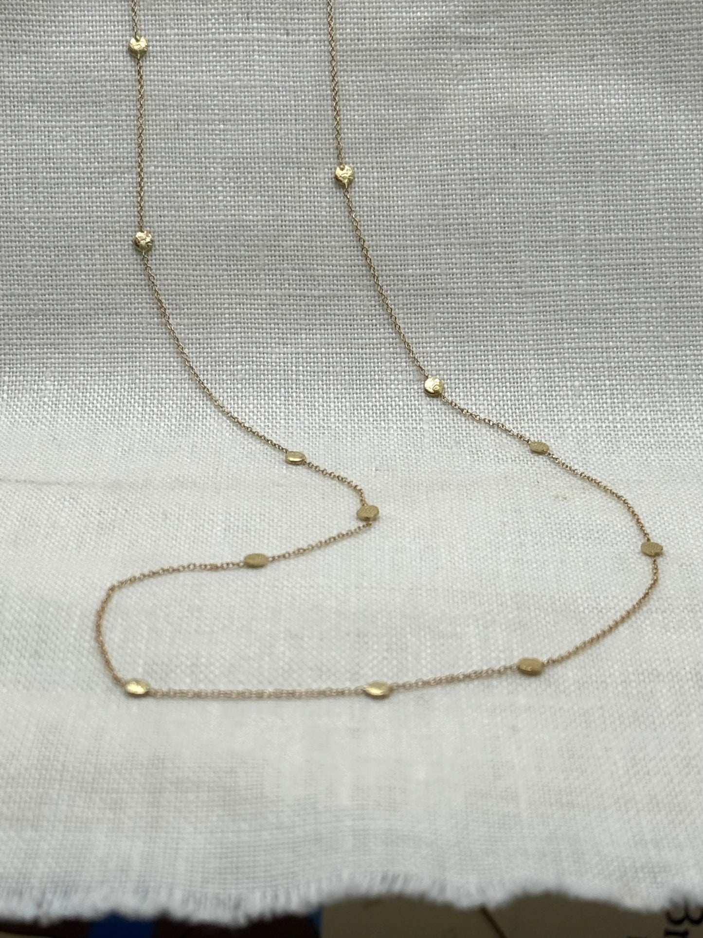 14k gold polka dot necklace with round bead stations on slender chain