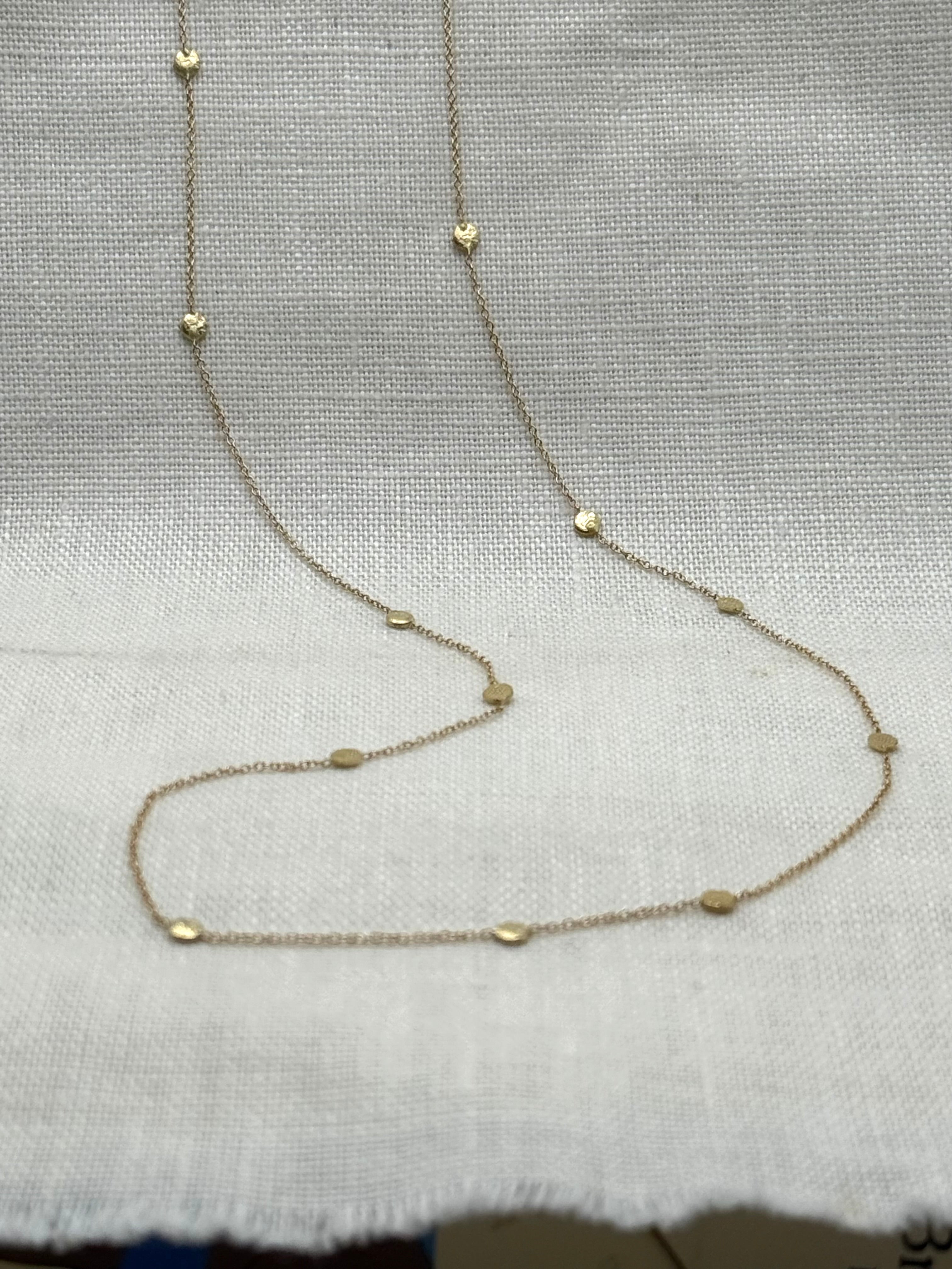 14k gold polka dot necklace with round bead stations on slender chain