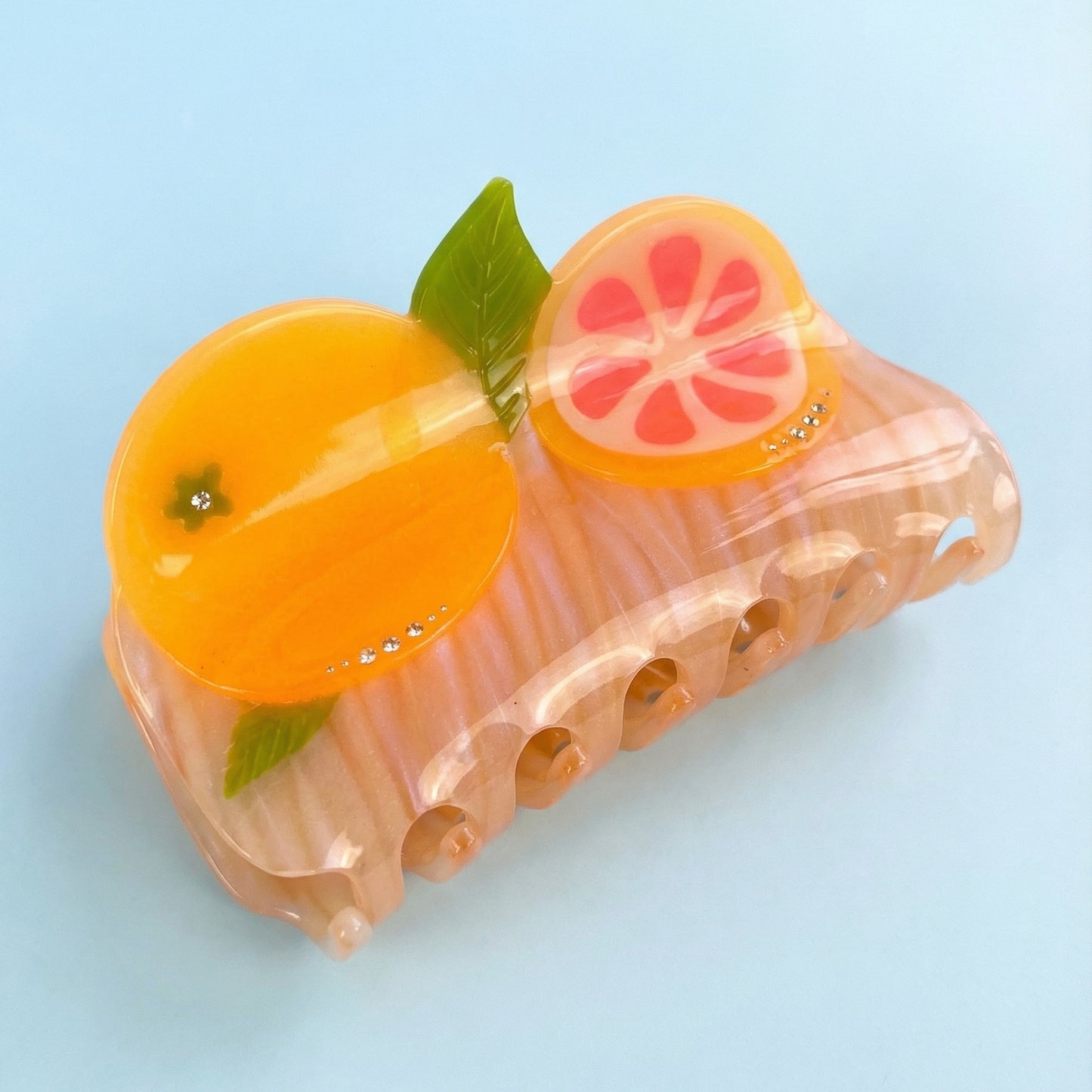 Pomelo fruit hair claw, translucent pink, orange slices, green leaves, rhinestone accents