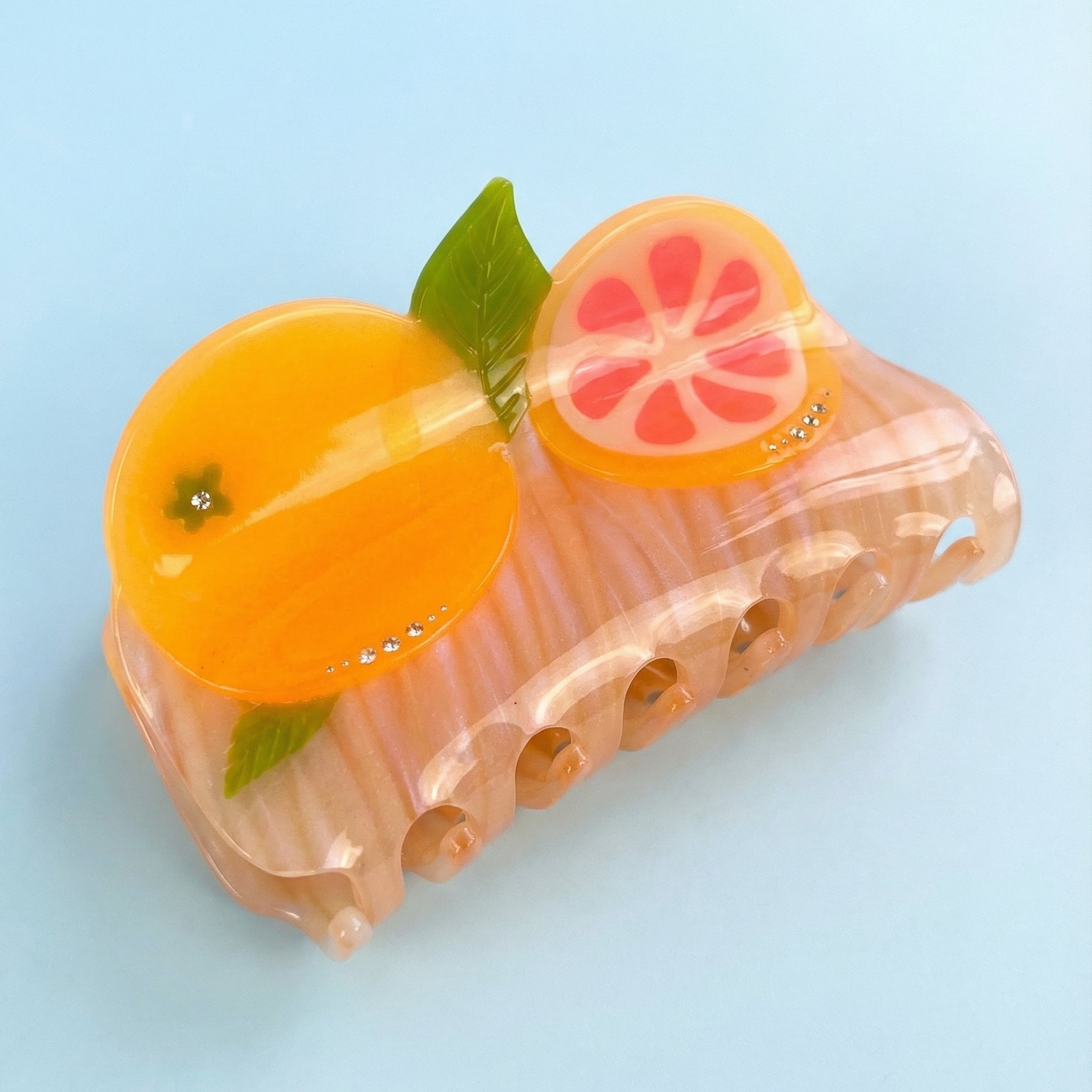 Pomelo fruit hair claw, translucent pink, orange slices, green leaves, rhinestone accents