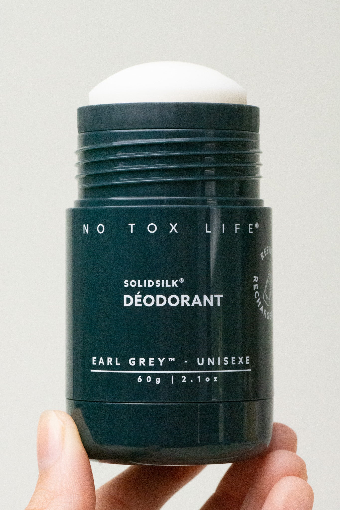 Refillable Solidsilk™ deodorant stick in dark navy with Earl Grey Unisex label