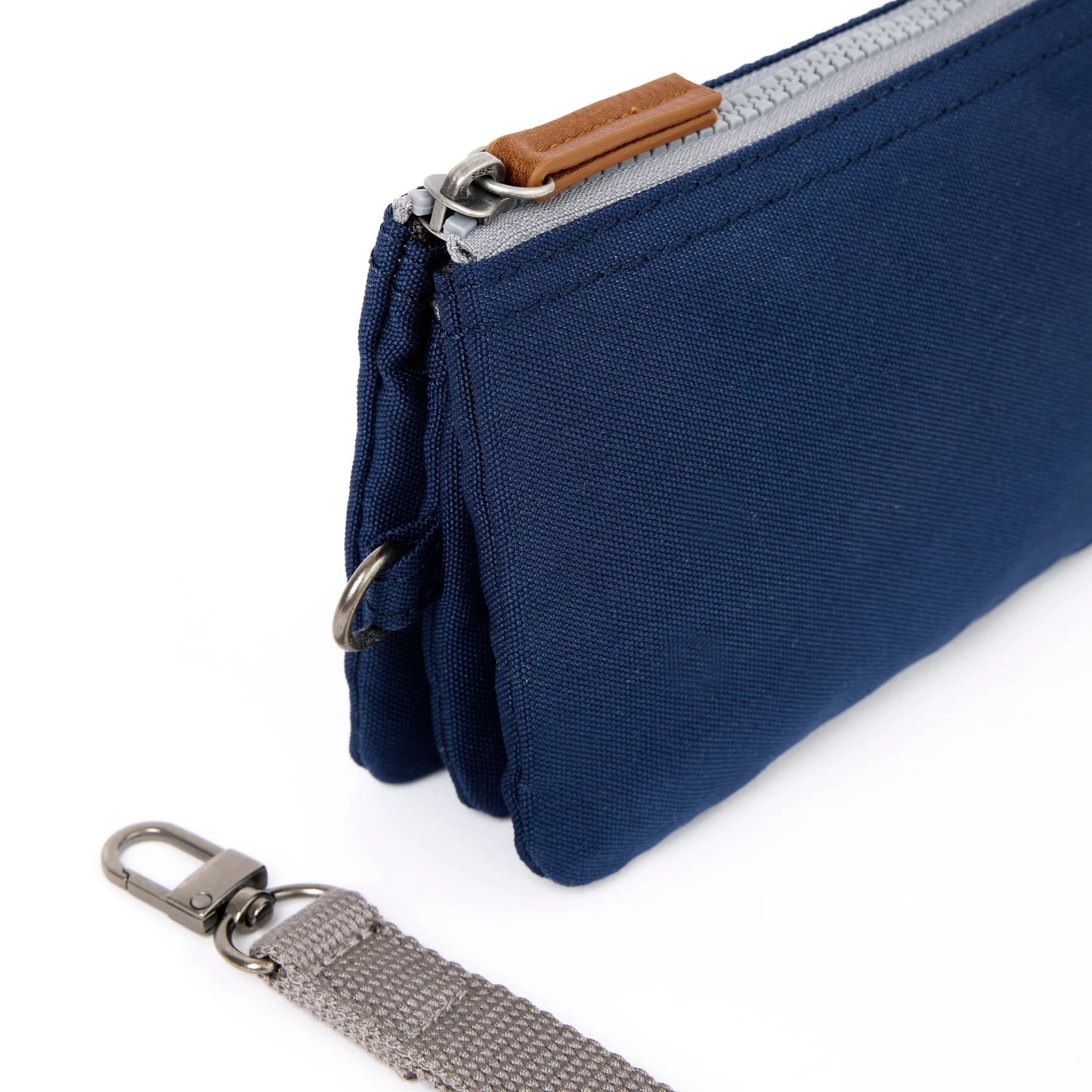 Medium recycled canvas zipper pouch side view in navy with key ring strap and tan zipper pull.