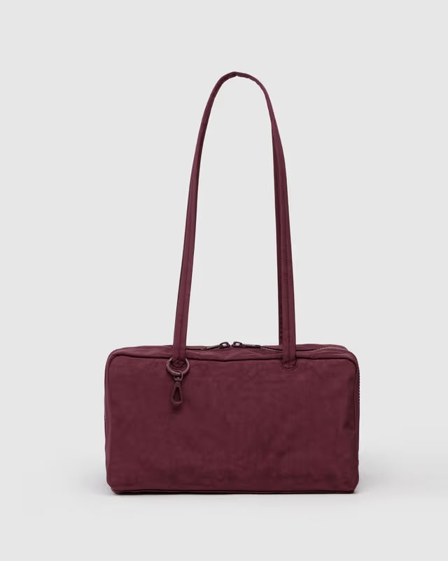Nylon bowler bag in burgundy with two top handles and zipper closure.