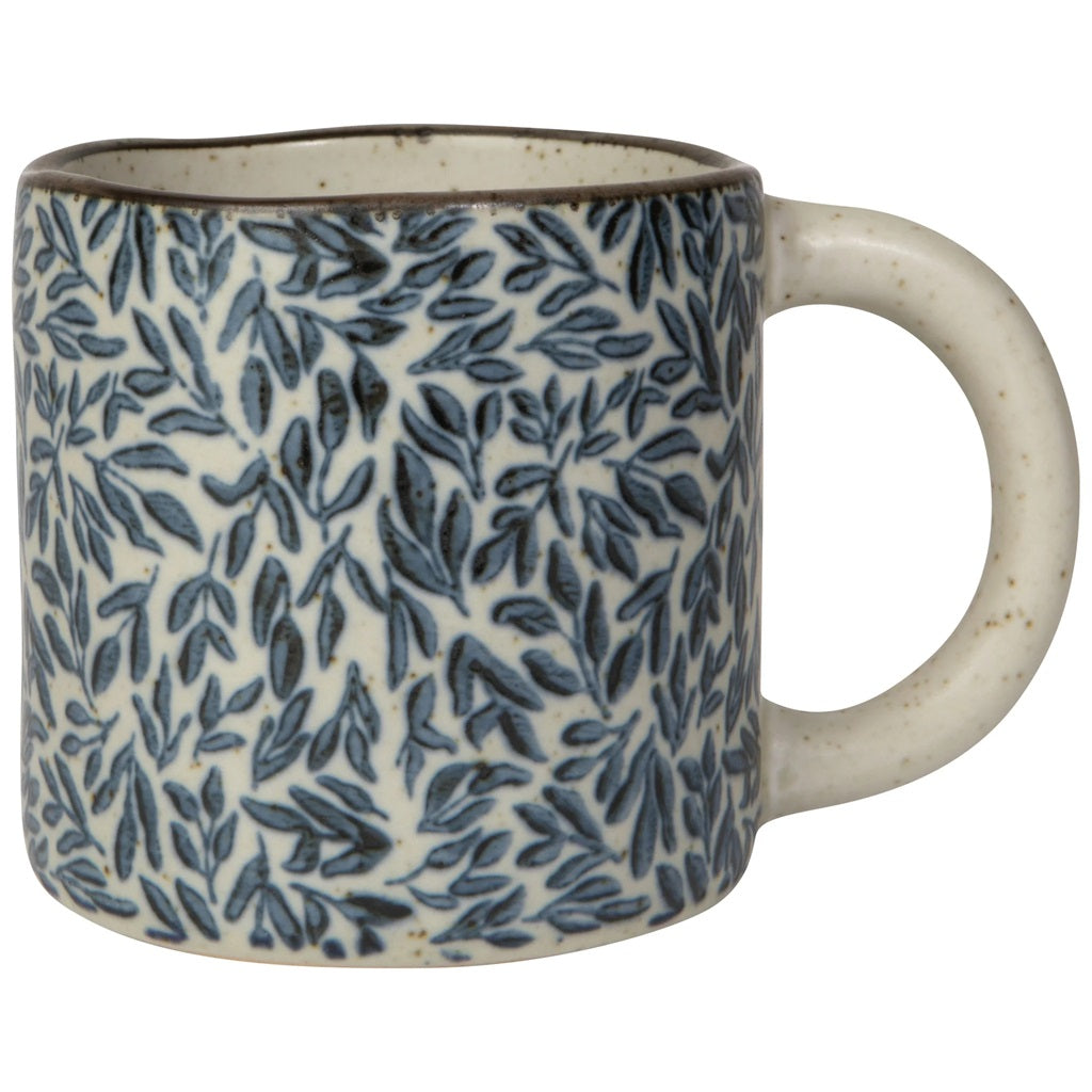 Ceramic mug with blue leaf pattern and cream handle, speckled rim