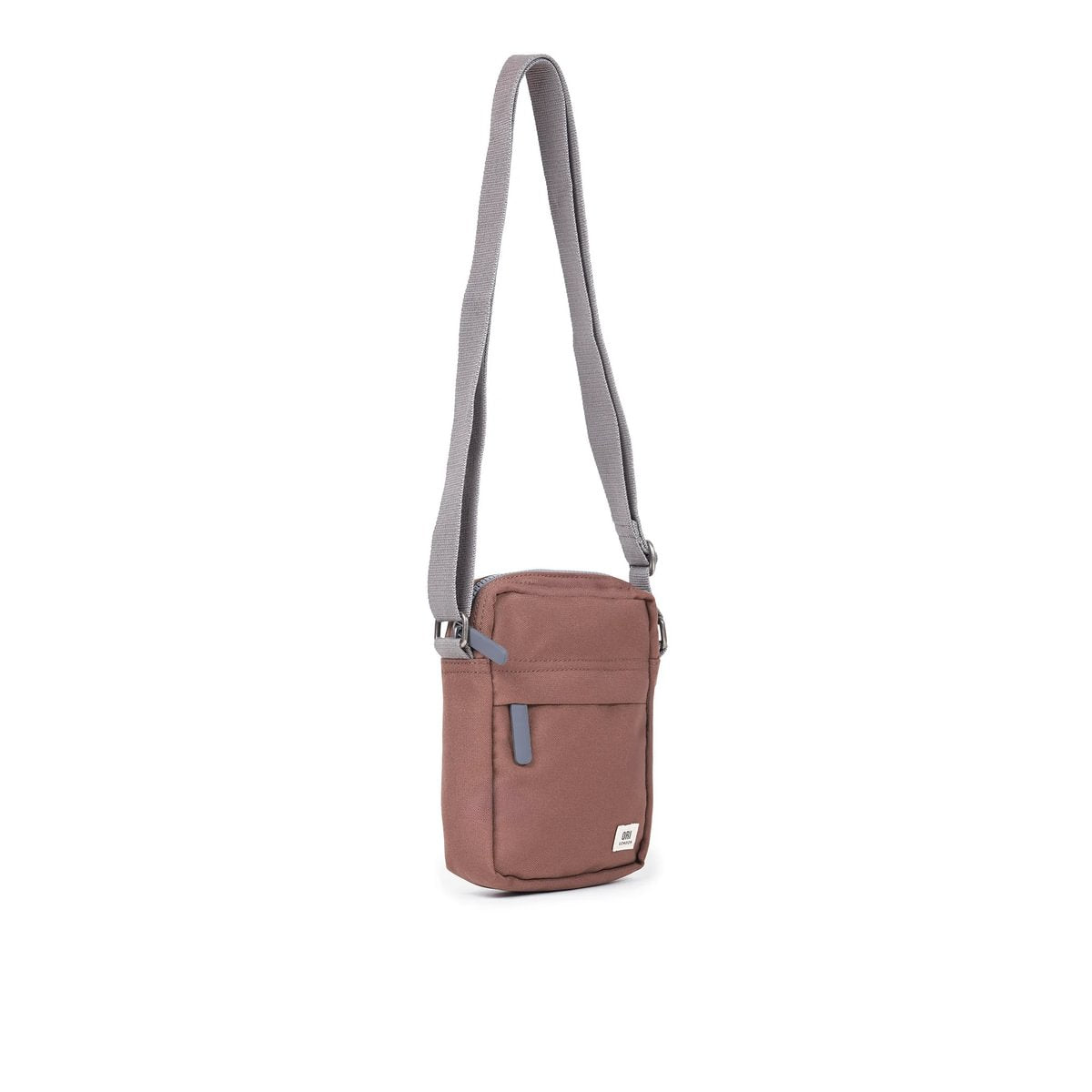 Dusty rose canvas crossbody bag with zip top, front pocket, and adjustable light strap