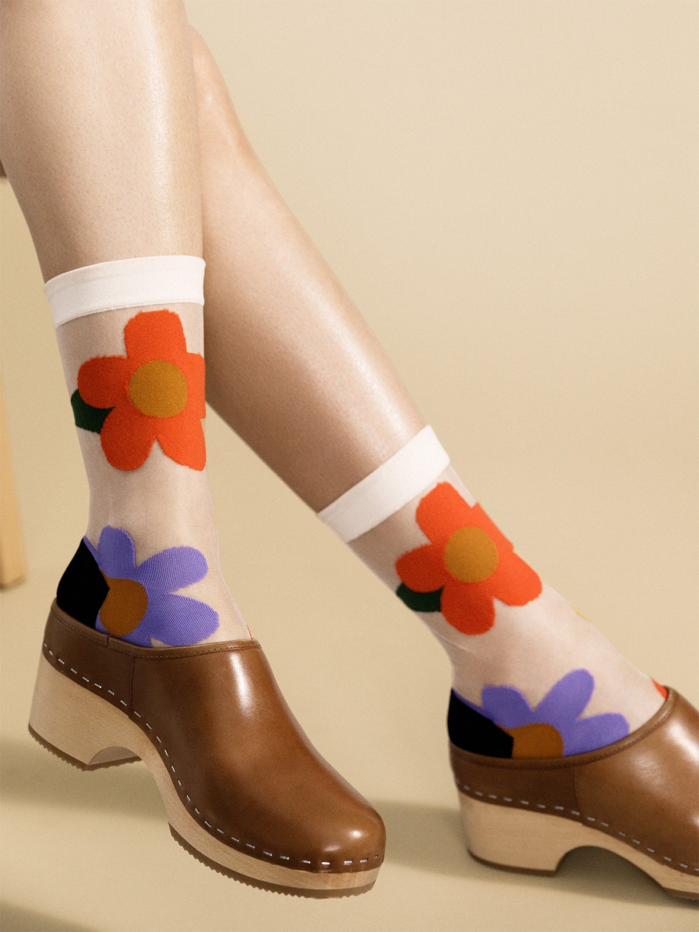 Sheer crew socks with orange, red, blue flower print and black toe tips