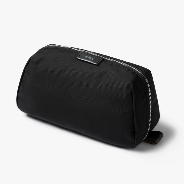 Black toiletry kit with zip-top closure and small brand label