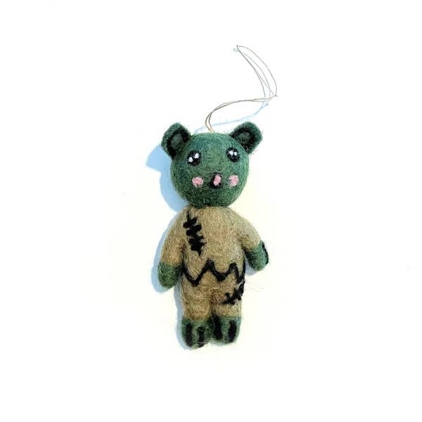 Green bear-like zombie wool ornament with beige body, stitched face, hanging loop