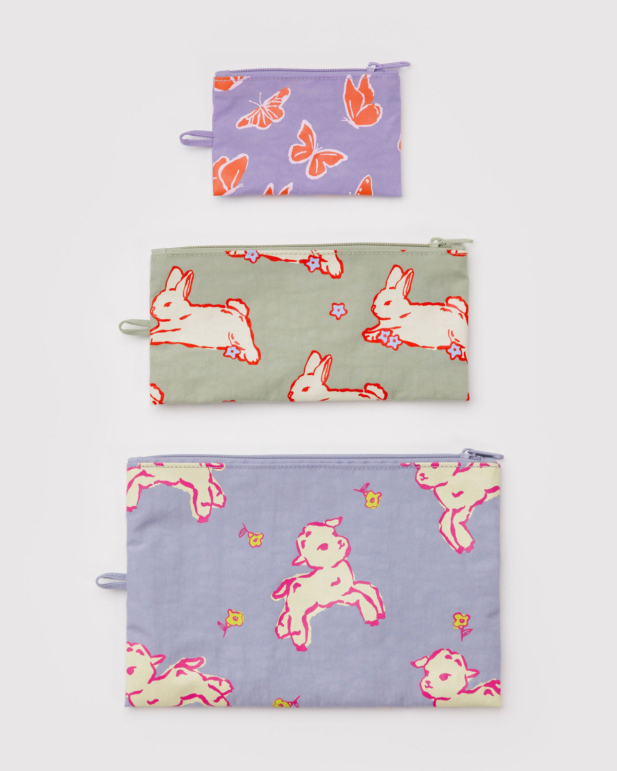 Set of three flat zipper pouches with butterflies and bunny prints in purple tones