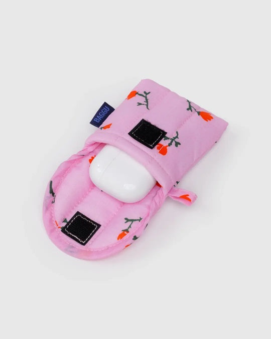 Dusty pink puffy earbuds case with bird print, black square patches, earbuds inside
