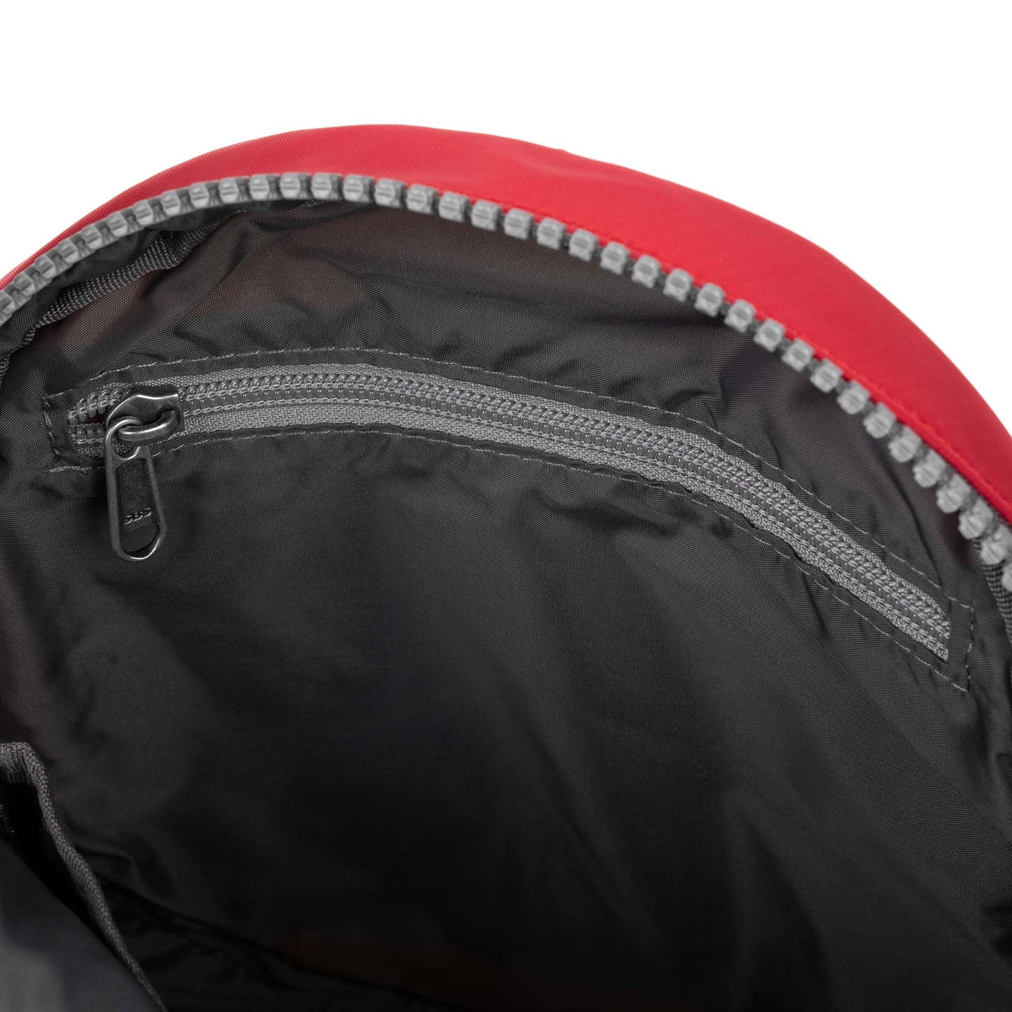 Recycled canvas crossbody bag interior with black lining and red exterior zip opening