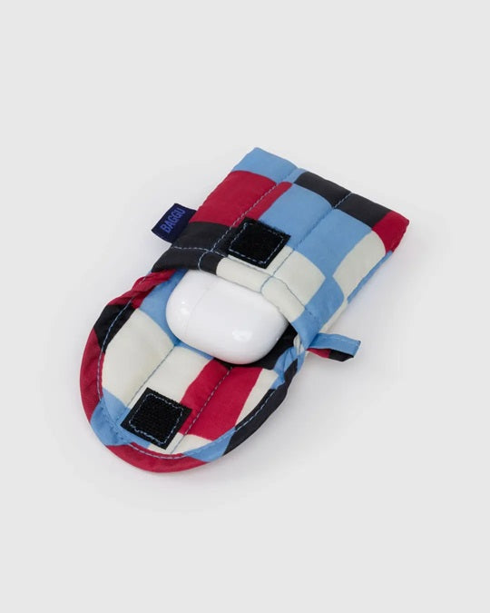 Puffy earbuds case with blue-and-red plaid stripes and black square patches, earbuds inside