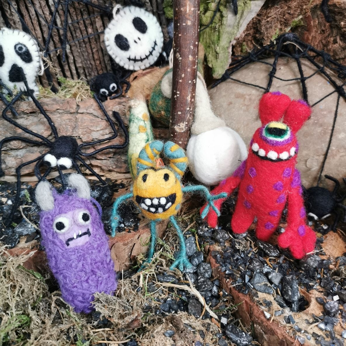Felt monster hanging decorations, several colorful characters with stitched faces