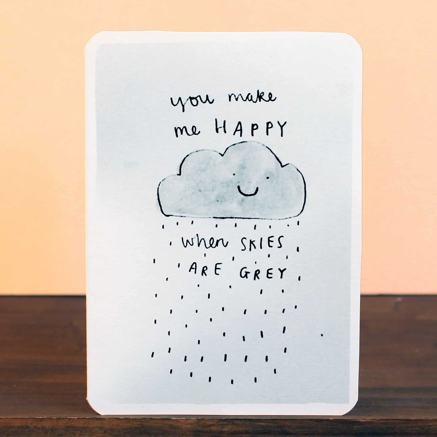 Greeting card with blue smiling cloud, grey rain, and 'you make me HAPPY' message