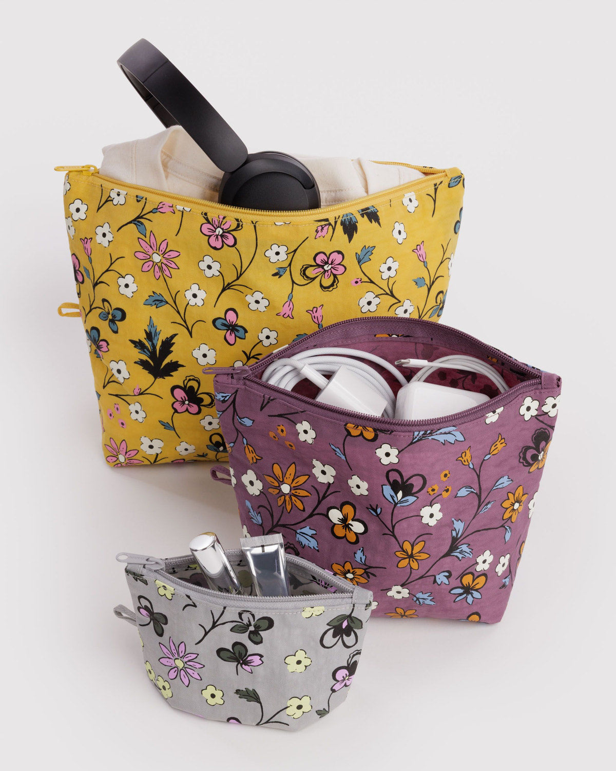 Go pouch set of three floral zip pouches with accessories, including a headphone