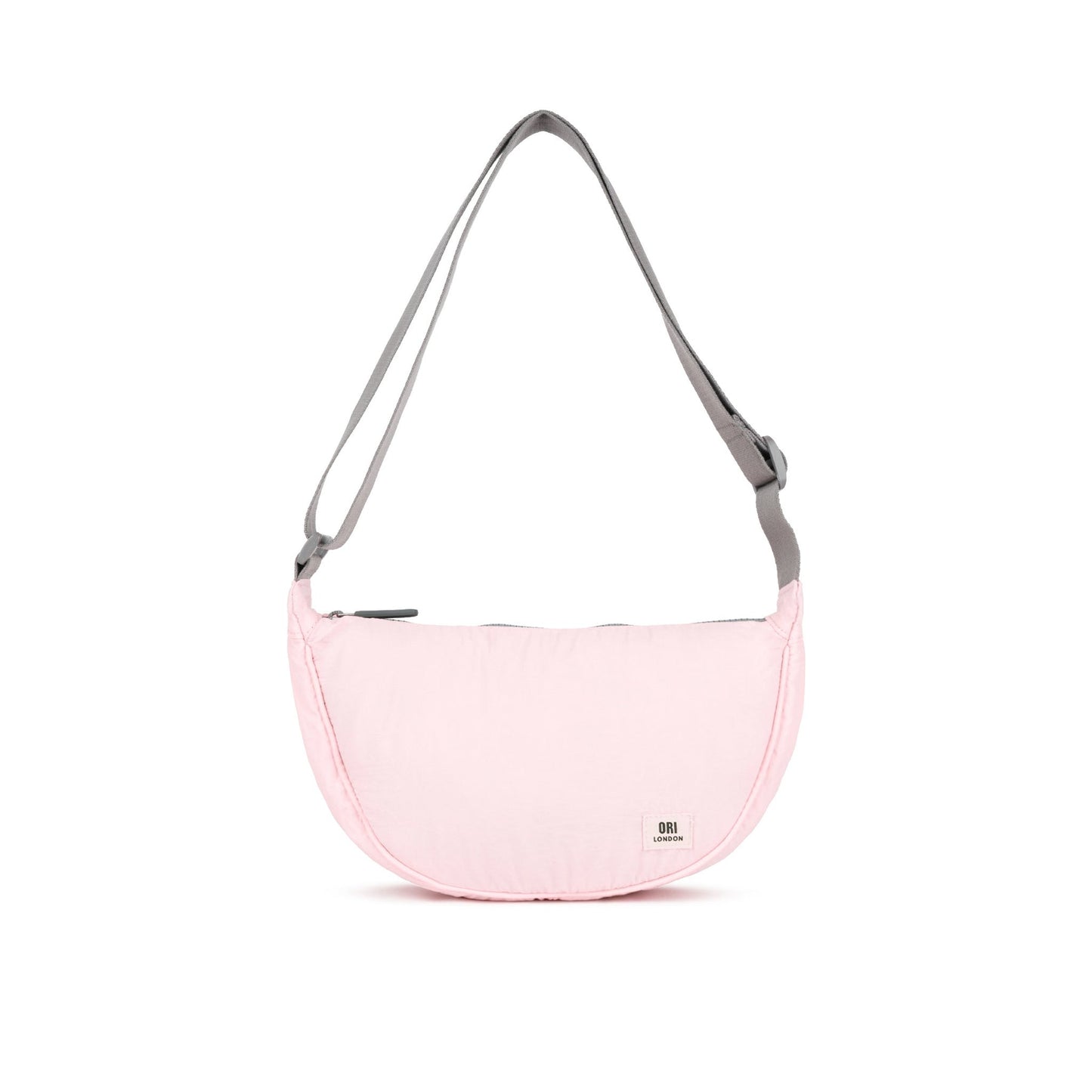 Seashell pink half-moon crossbody bag with gray webbing straps and zip top.