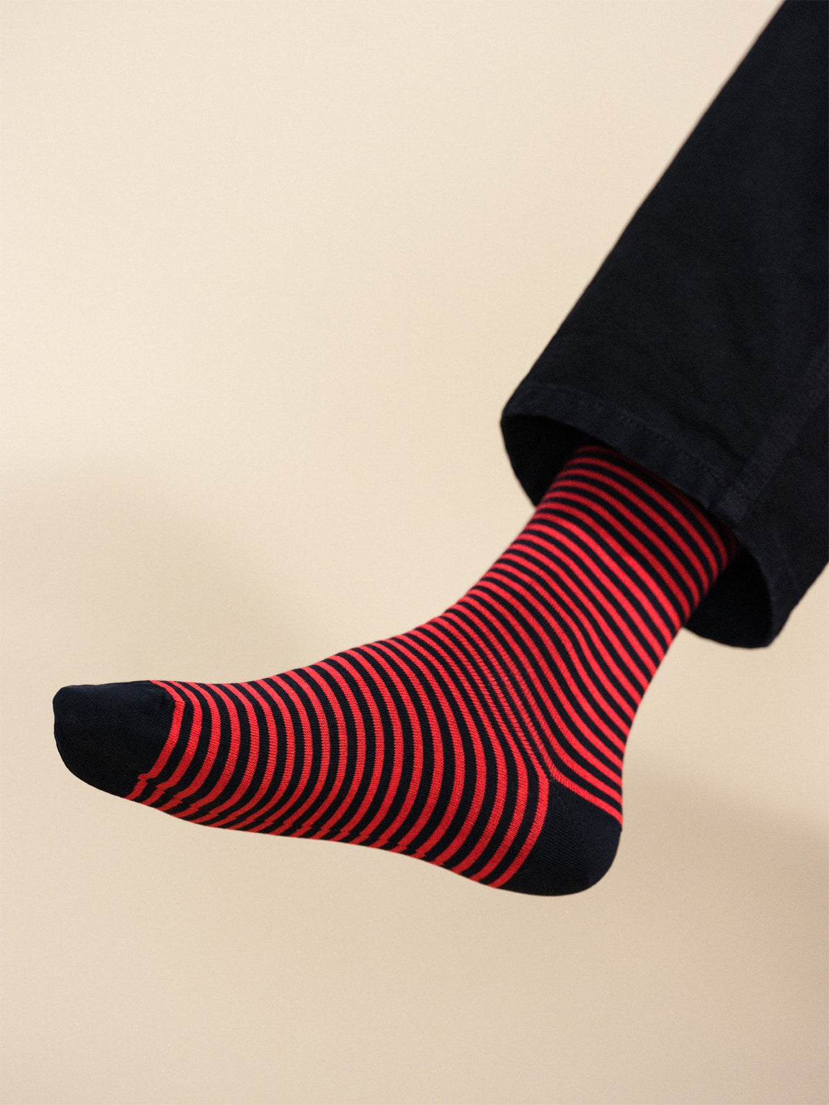 Single men's crew sock with navy-red striped knit and anchor emblem on side