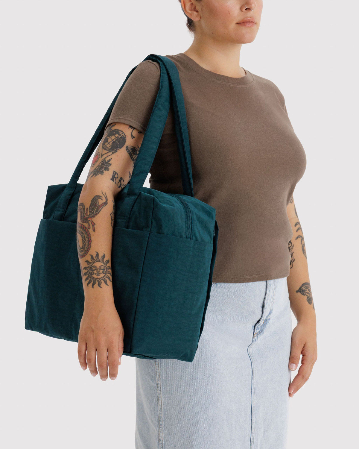 Teal carry-on tote bag worn on the shoulder with top handles