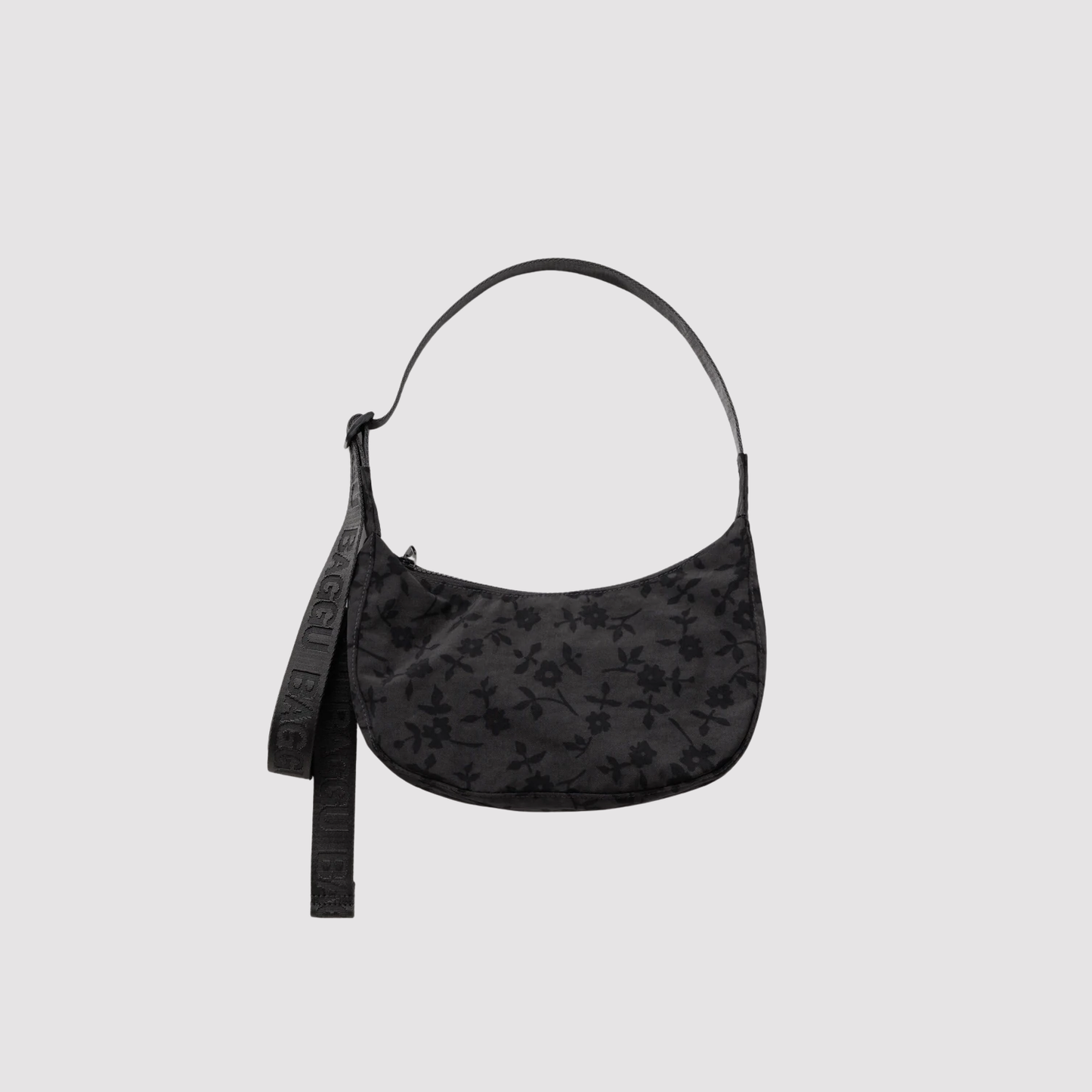 Small nylon crescent bag, black with subtle floral pattern and wrist strap