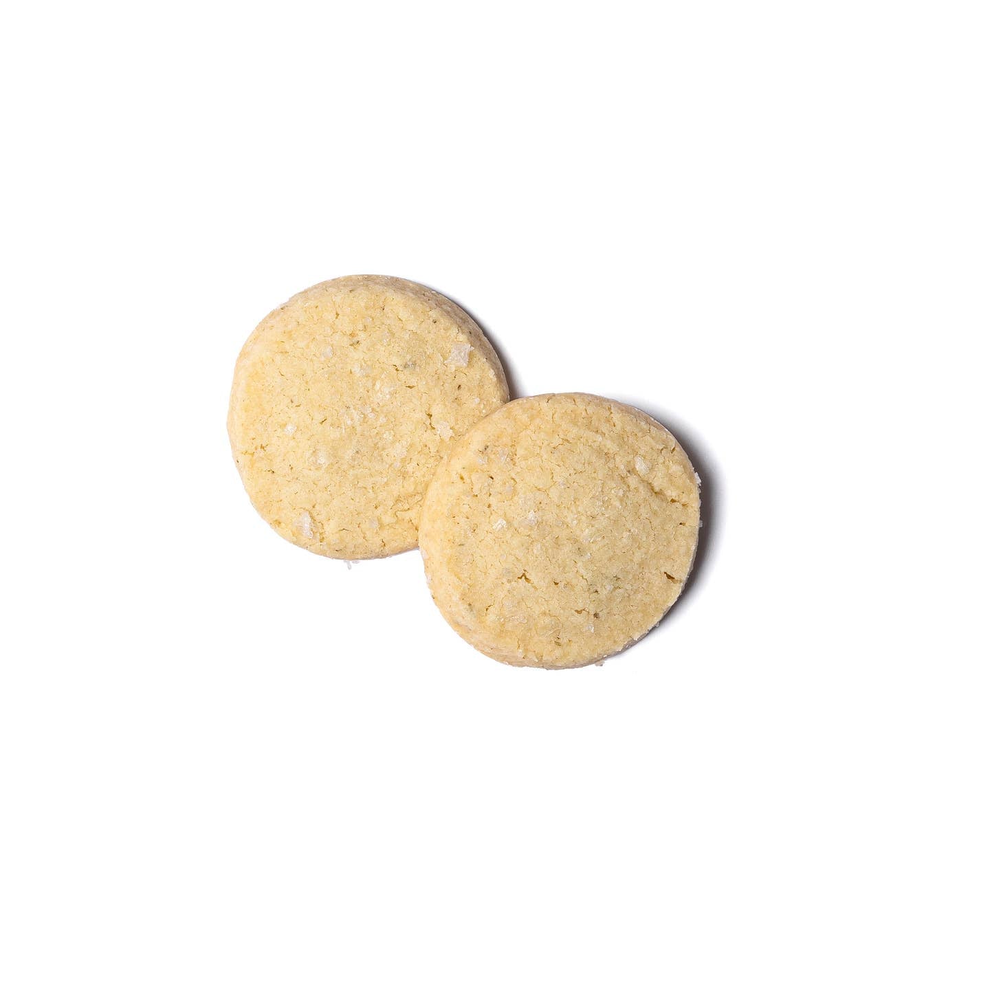 Rosemary sea salt shortbread cookies, two round light-golden cookies