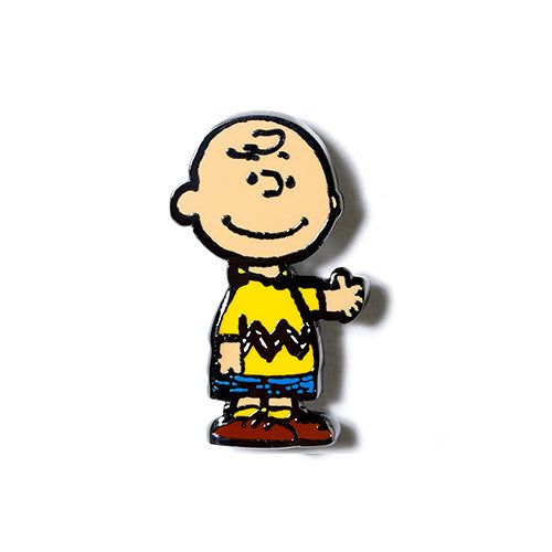 Charlie Brown enamel pin with smiling face, yellow shirt, and blue pants