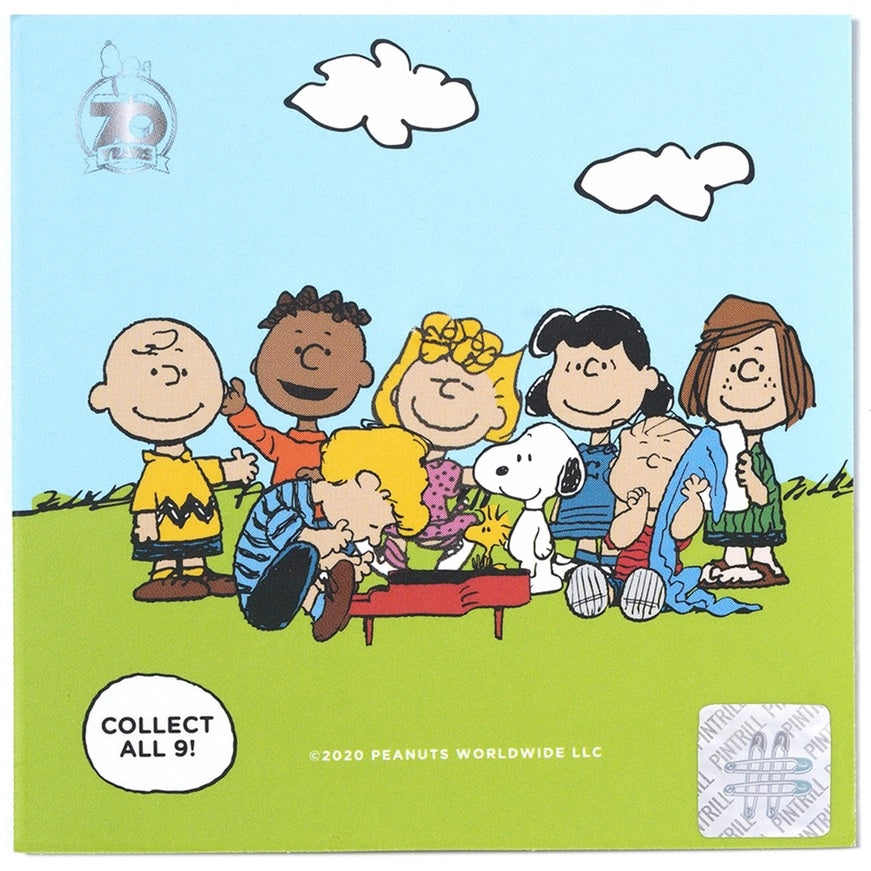 Peanuts collectibles card featuring a group illustration and a small Charlie Brown pin