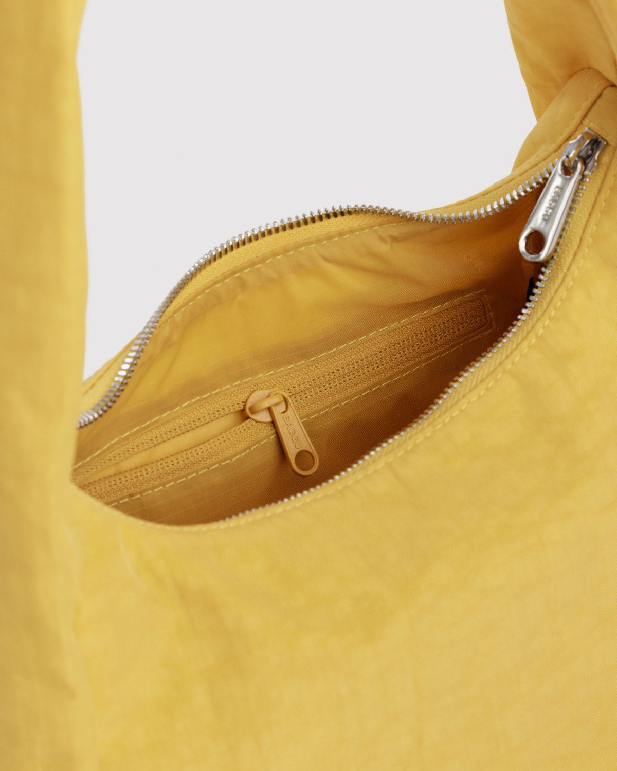 Small nylon meringue bag, open zip top with gold interior and drawcord detail