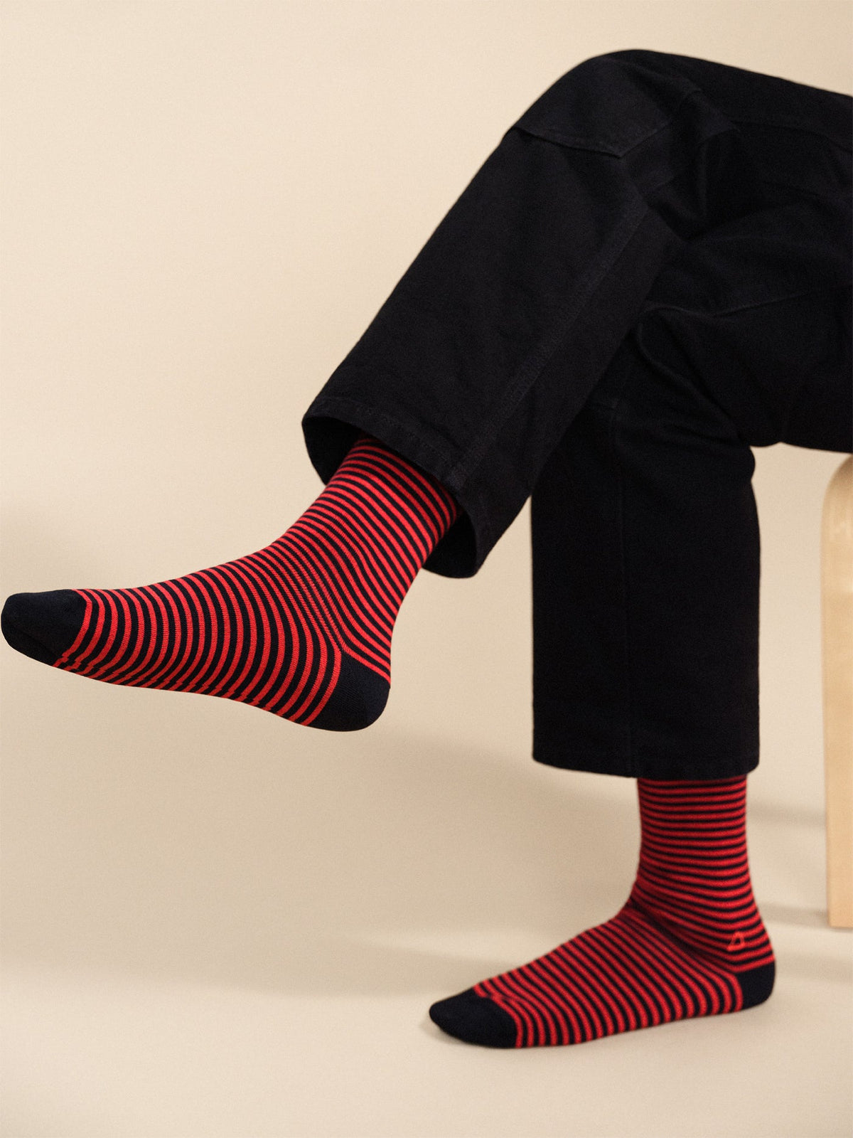 Pair of men's crew socks, navy with red striped pattern and anchor detail