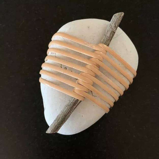White rock decor wrapped with natural cane bands and wood stick